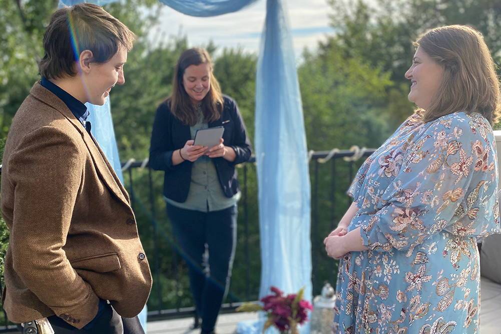 Two people standing at an alter about to be married.