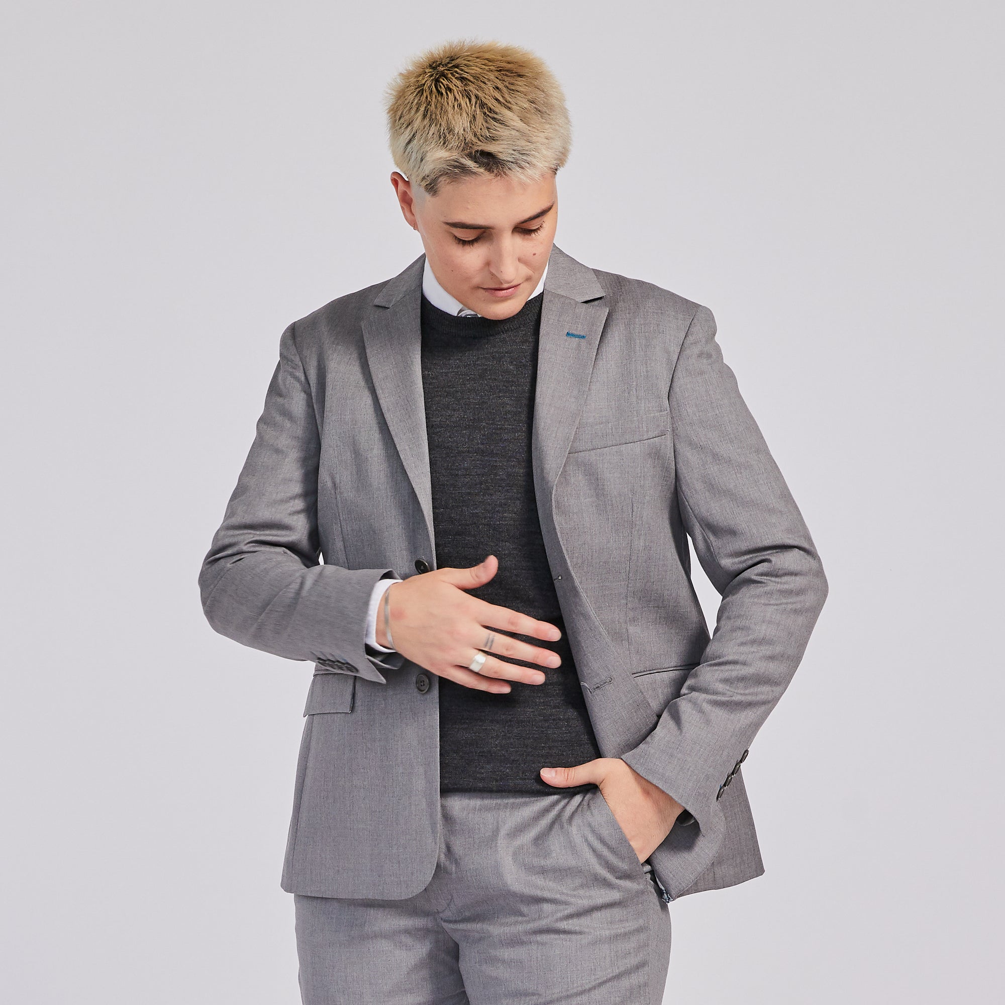 Androgynous person in Georgie light gray suit blazer by Kirrin Finch.  Color: Light Gray