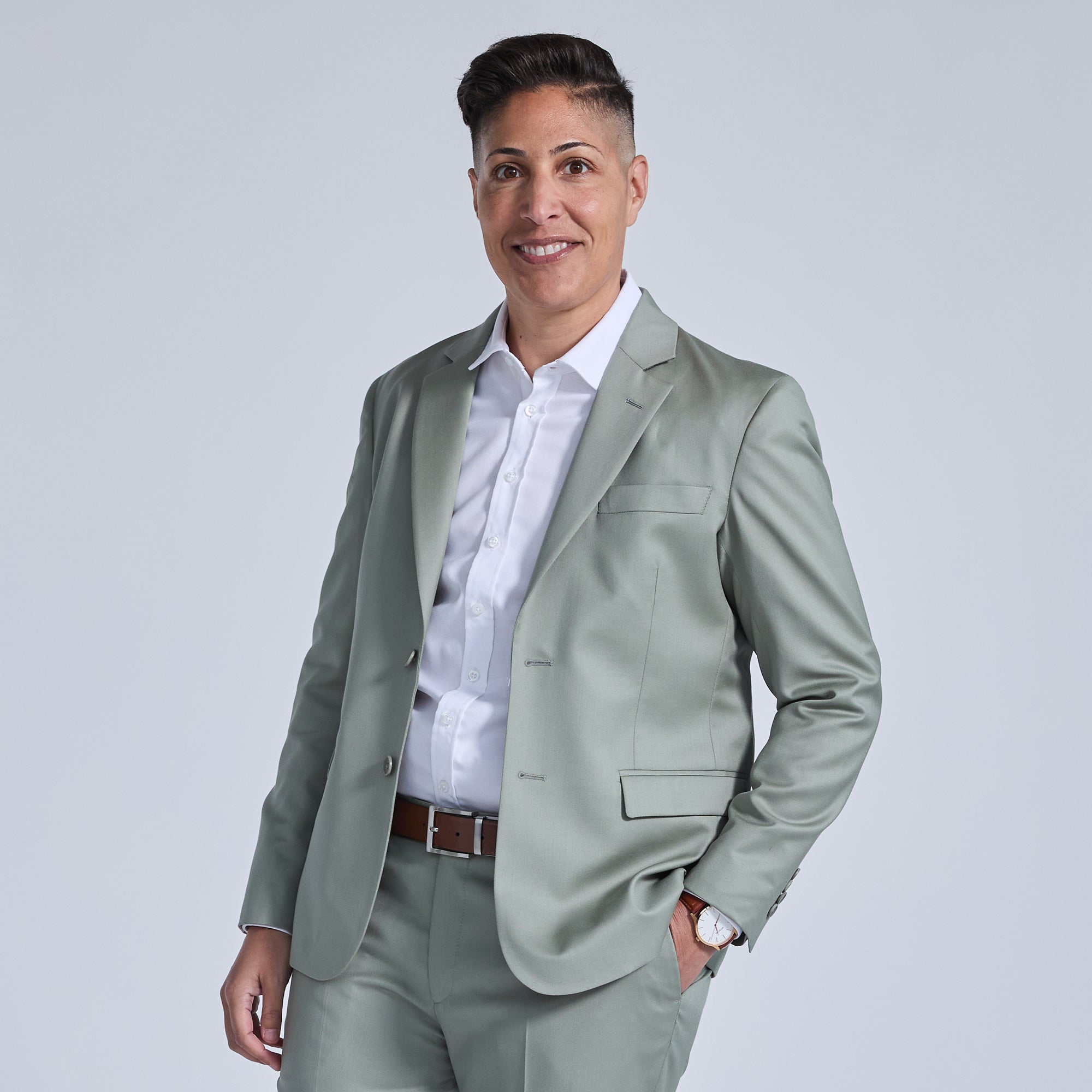 Androgynous person in the Georgie sage suit blazer. Color: Sage