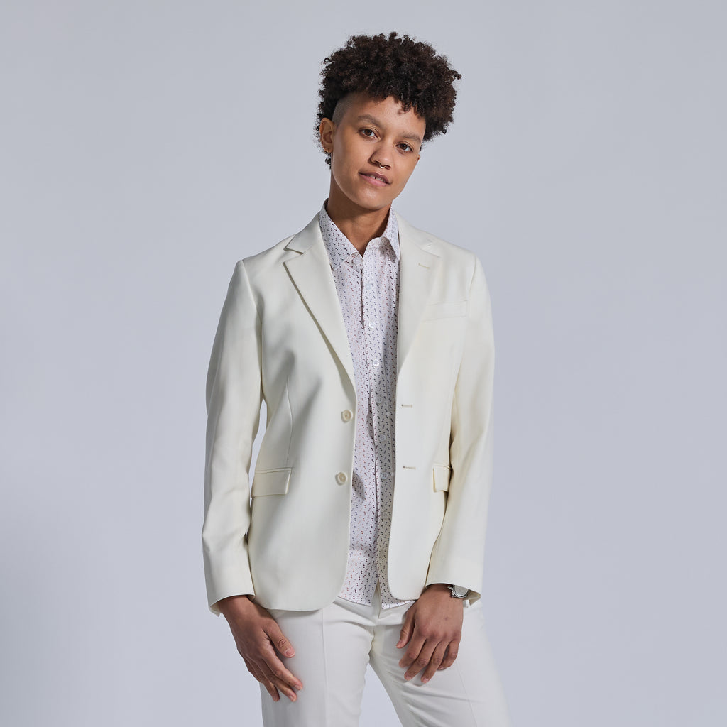 Non-binary model in Ivory Wedding Suit by Kirrin Finch. Color: Ivory