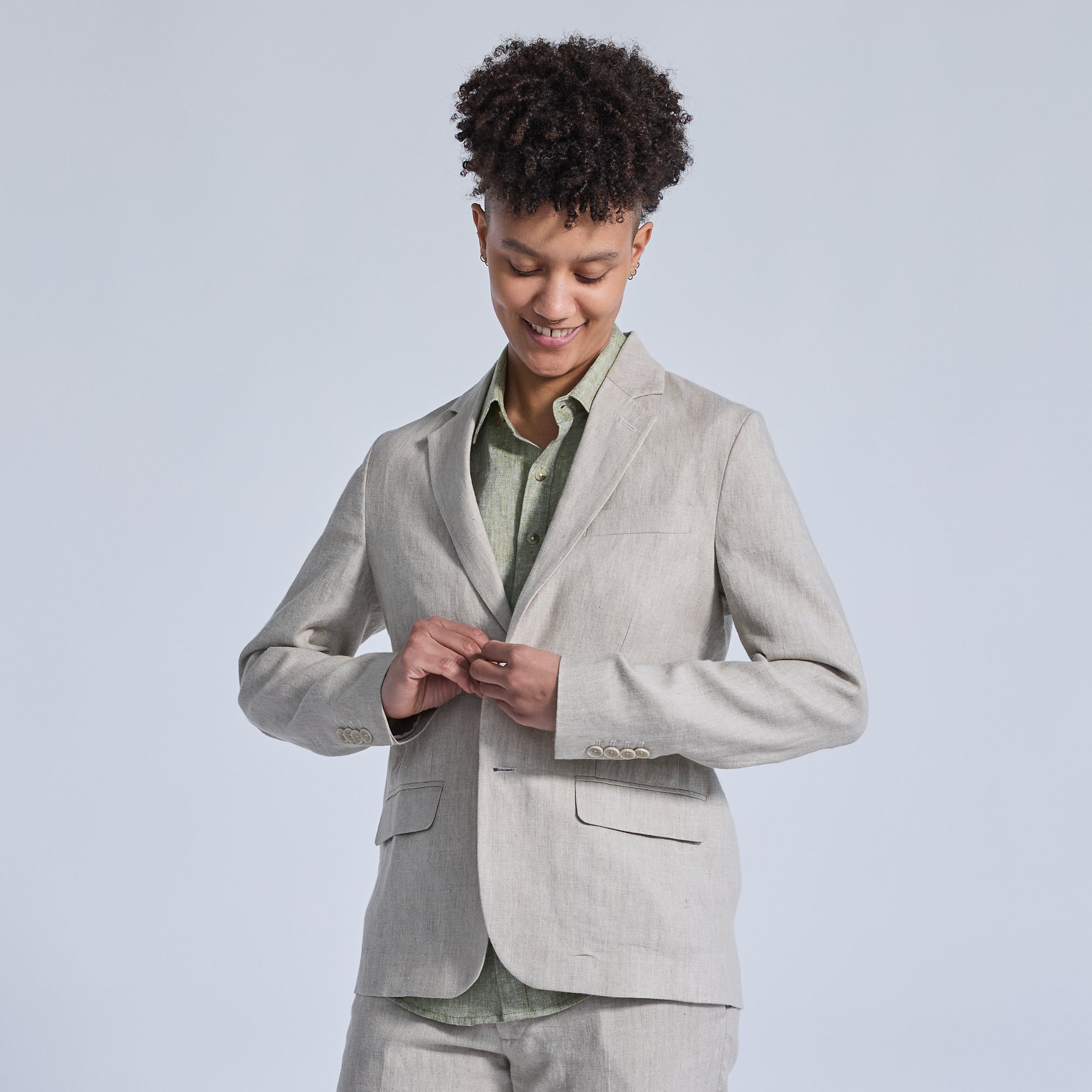 non-binary model in sand linen suit with sage linen shirt.  Color: Oat