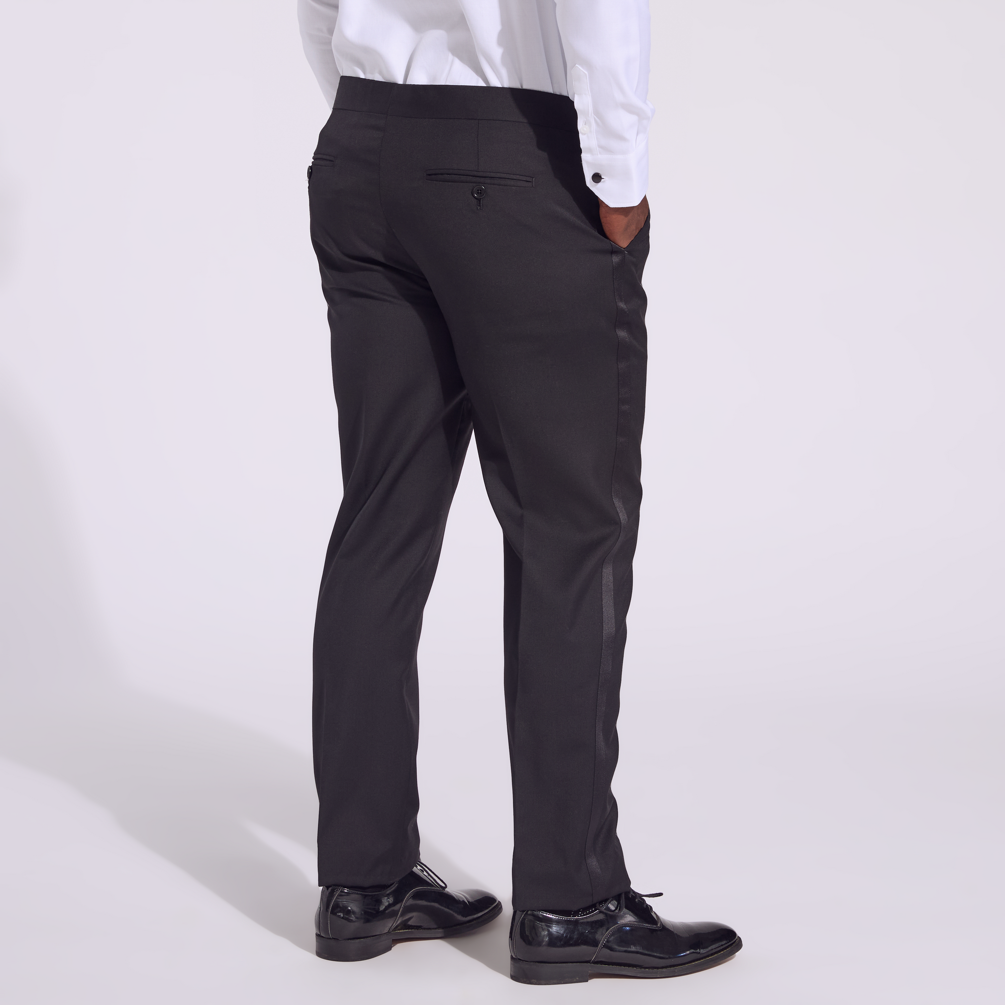 Transmasc model wearing Noir Tuxedo pants by Kirrin Finch. Color: Noir