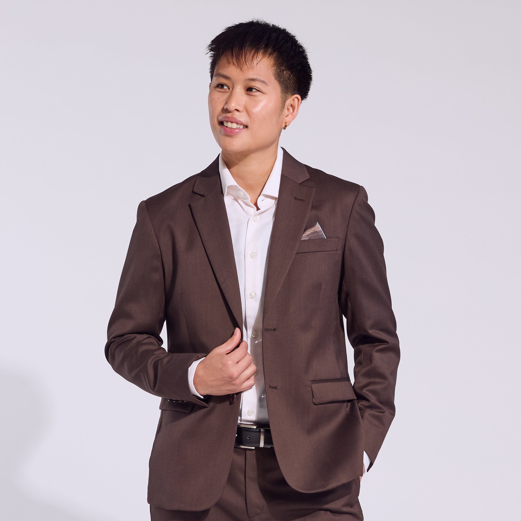 Masc person in the Georgie Chocolate Brown suit. Color: Chocolate