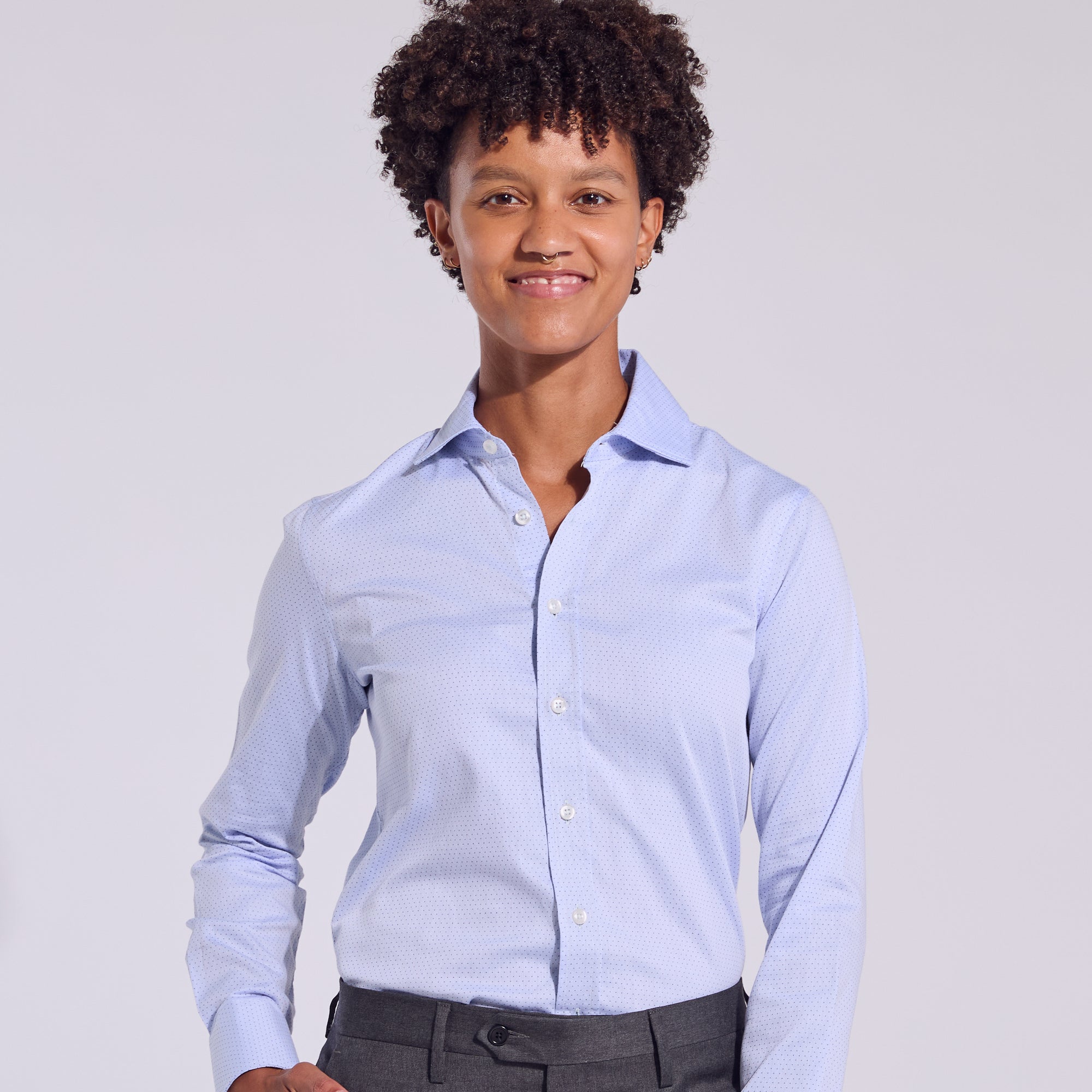 Androgynous person in the business casual swiss dot dress shirt.  Color: Blue Swiss Dot