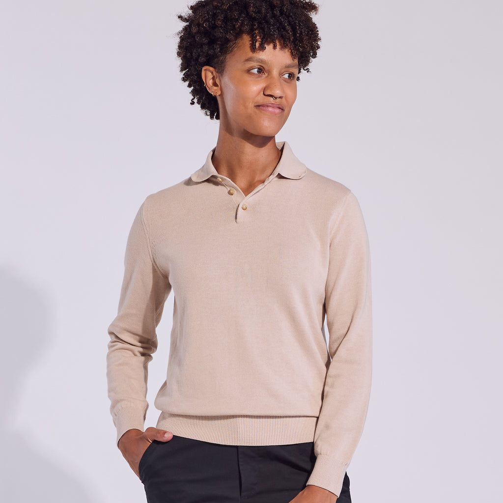 Model cream long sleeve polo sweater with a collar, three button closure at the neck, ribbed cuffs and hem, in a relaxed fit. Color: Cream