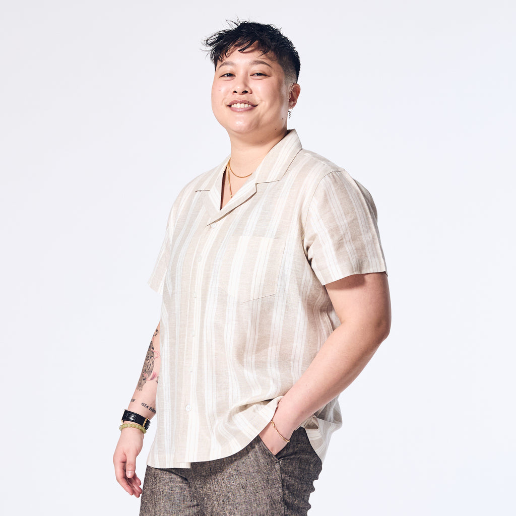 Model wearing Sand Wide Stripe Linen Camp Shirt made by Kirrin Finch. Color: Sand Wide Stripe