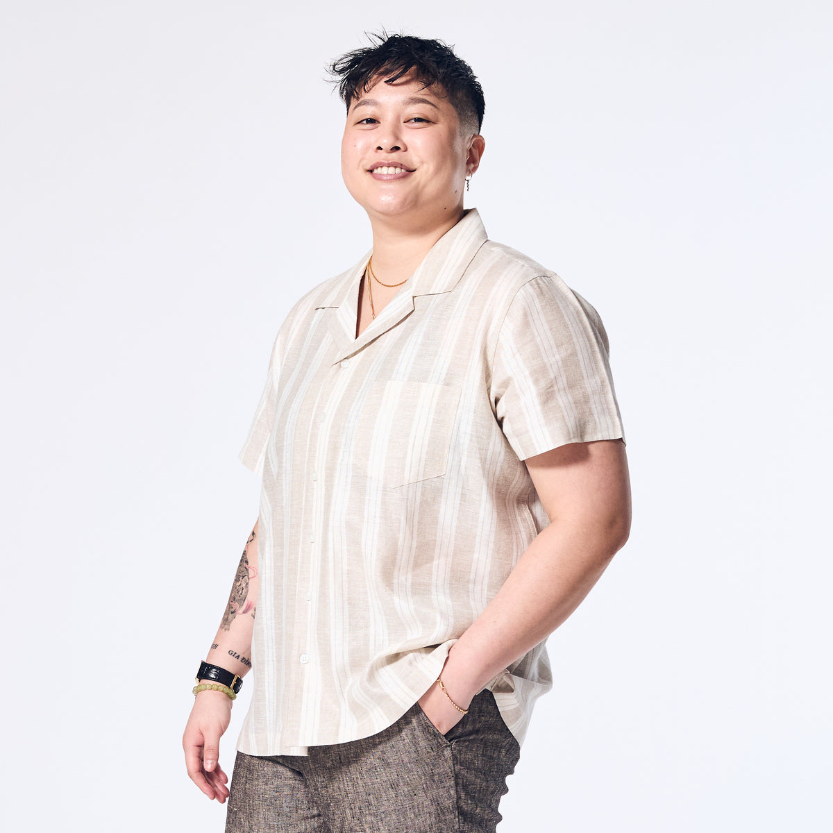 Model wearing Sand Wide Stripe Linen Camp Shirt made by Kirrin Finch. Color: Sand Wide Stripe