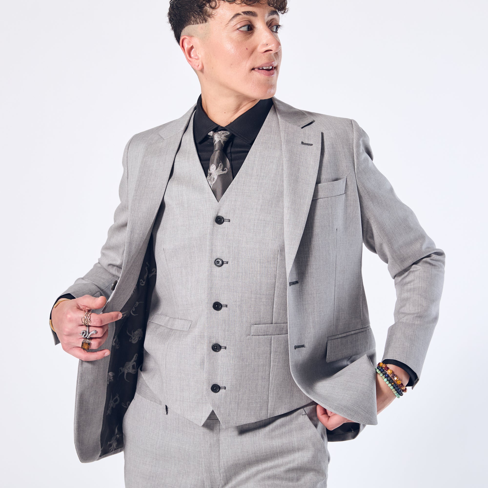 Masc person in Sky Gray Suit by Kirrin Finch.  Color: Sky Gray