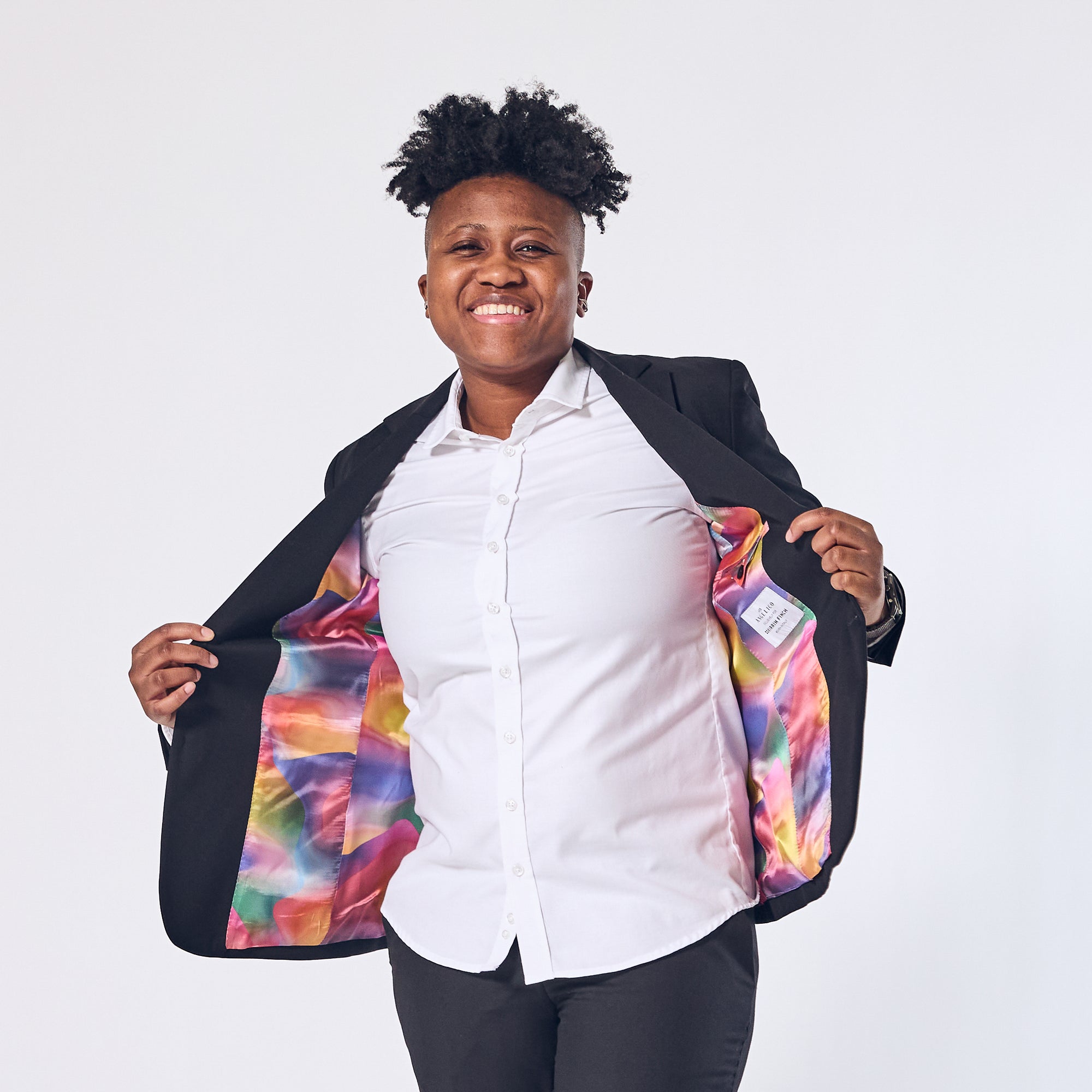 Androgynous person in Kirrin Finch's Georgie Pride Blazer. Color: Pride Edition