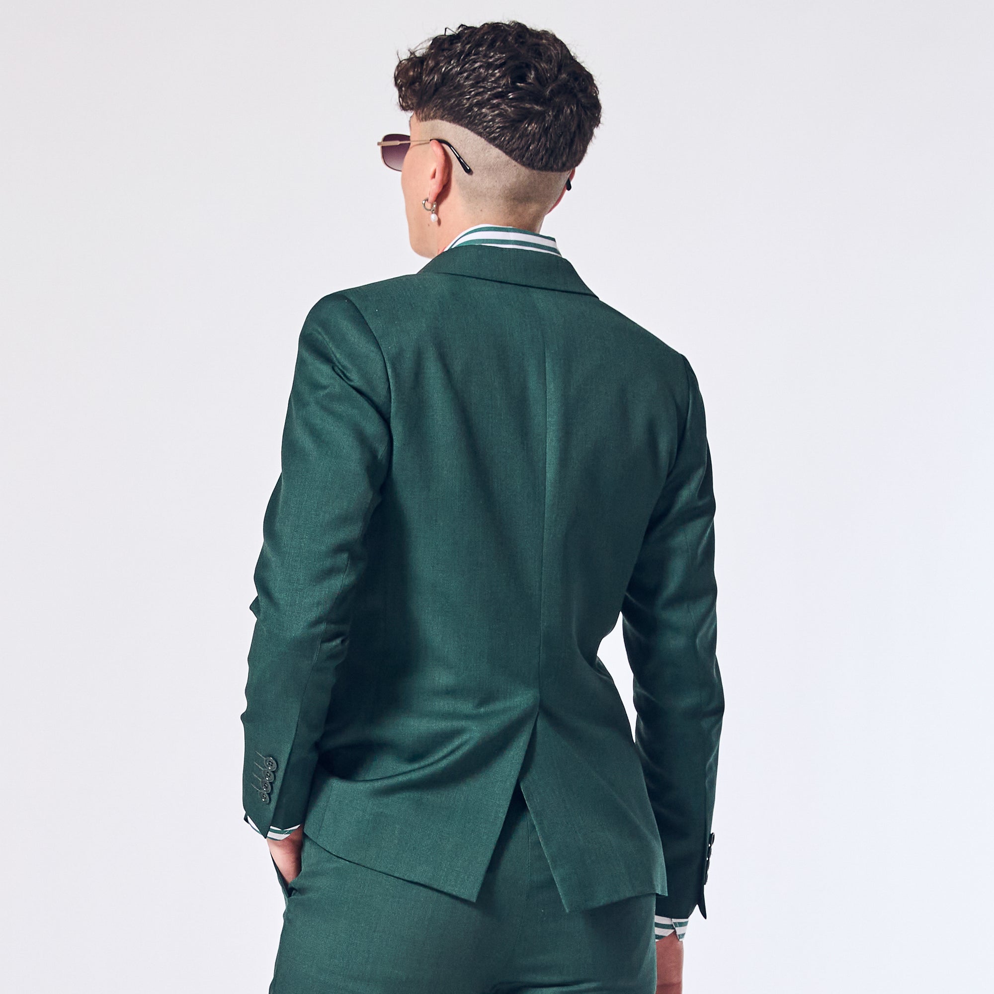 Androgynous model in Emerald Green Suit made for women, trans, and non-binary folk. Color: Emerald