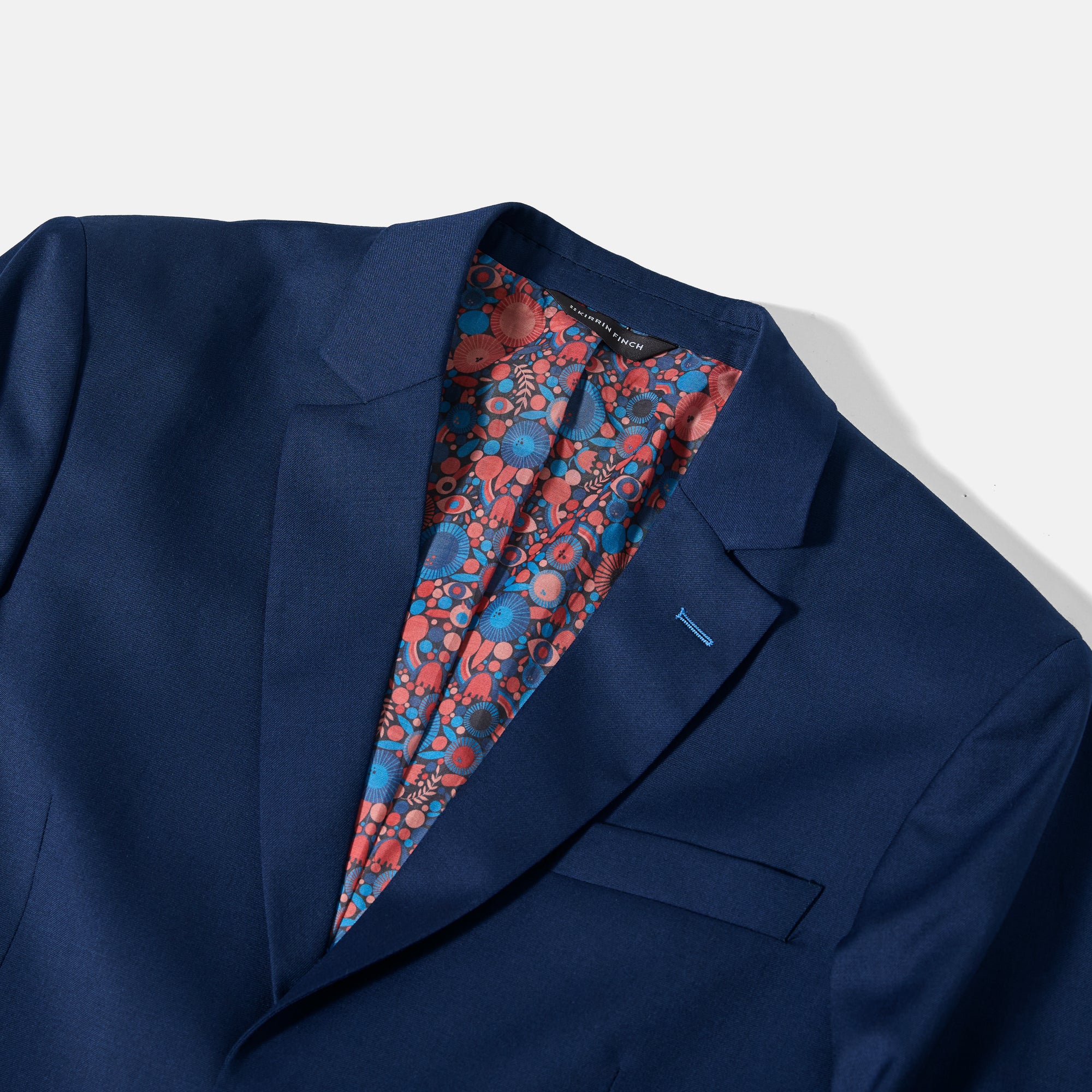 Navy blue suit jacket with a colorful floral lining on a white background. Color: Navy Lisa C