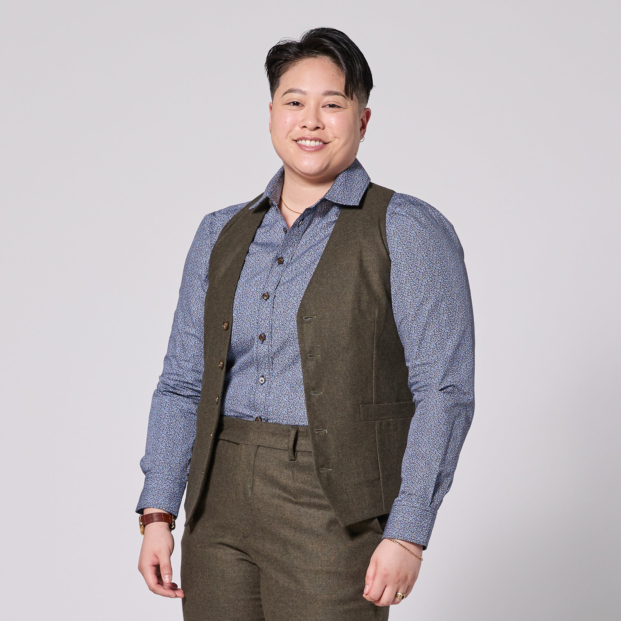 Model wearing the Finch Heather Olive Flannel vest on a solid white background.  Color: Heather Olive Flannel