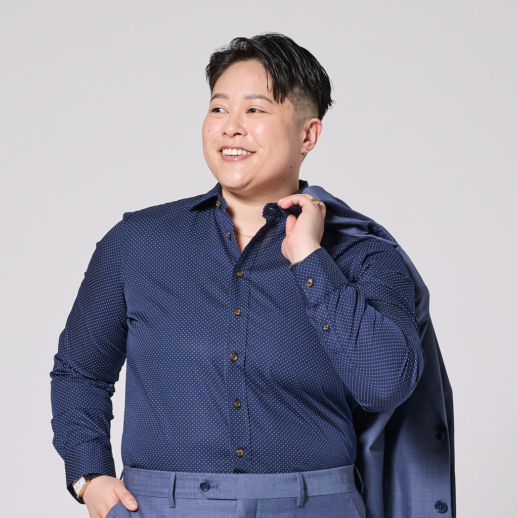 Masc presenting person in Blue Microdot Dress Shirt by Kirrin Finch.  Color: Stella