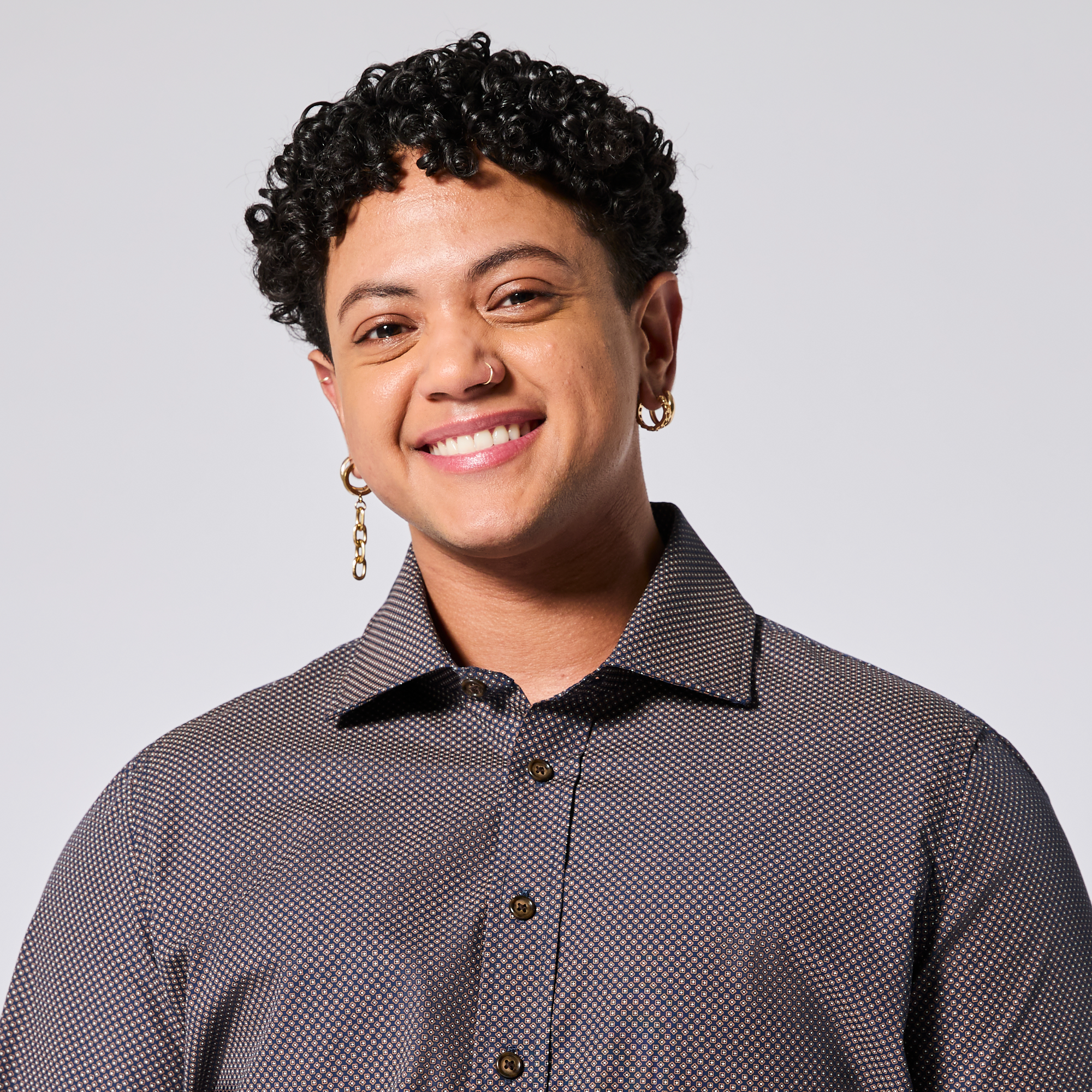 Model wearing a patterned shirt against a plain background. Color: Moroccan Tile