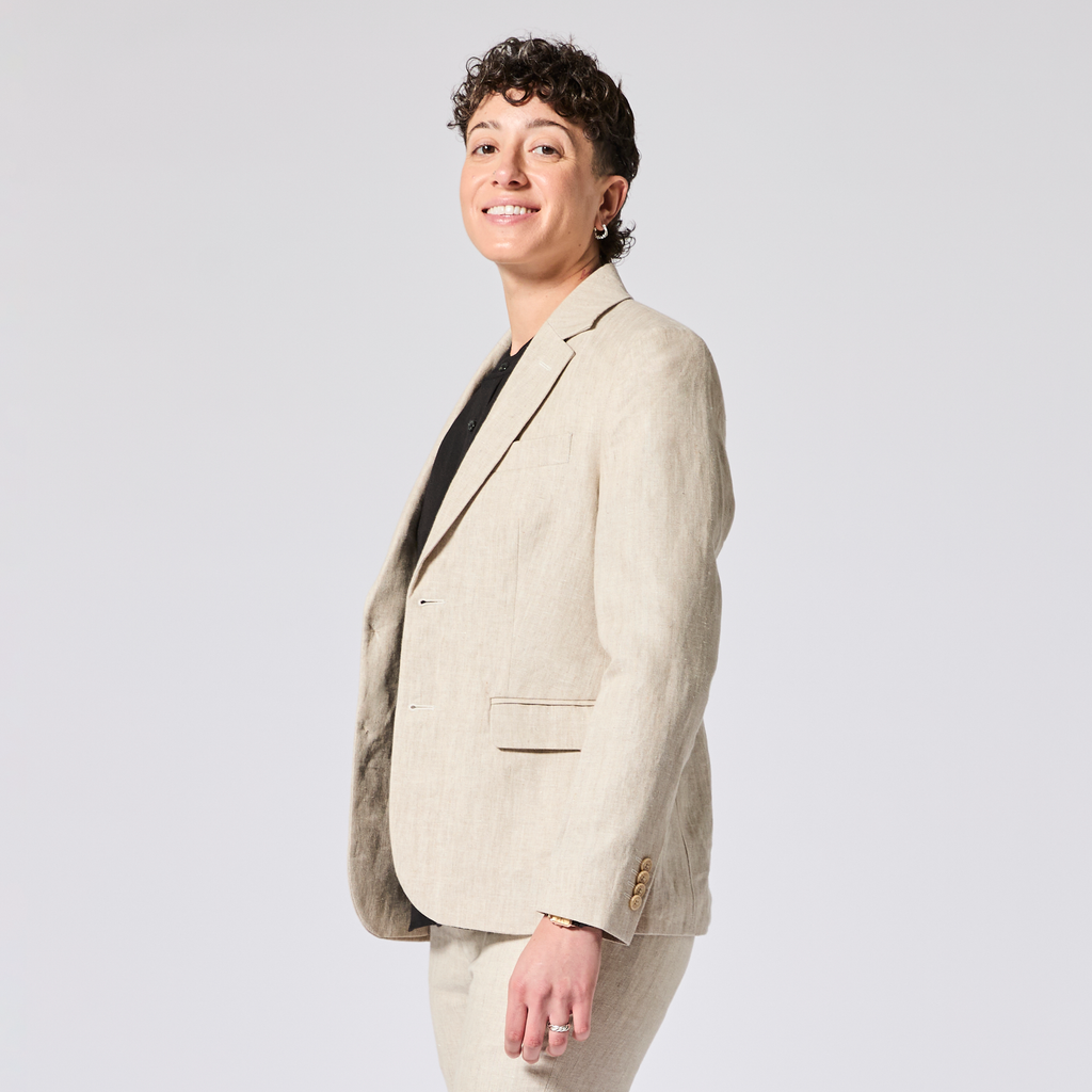 Person wearing a beige blazer on a plain background. Color: Khaki Herringbone