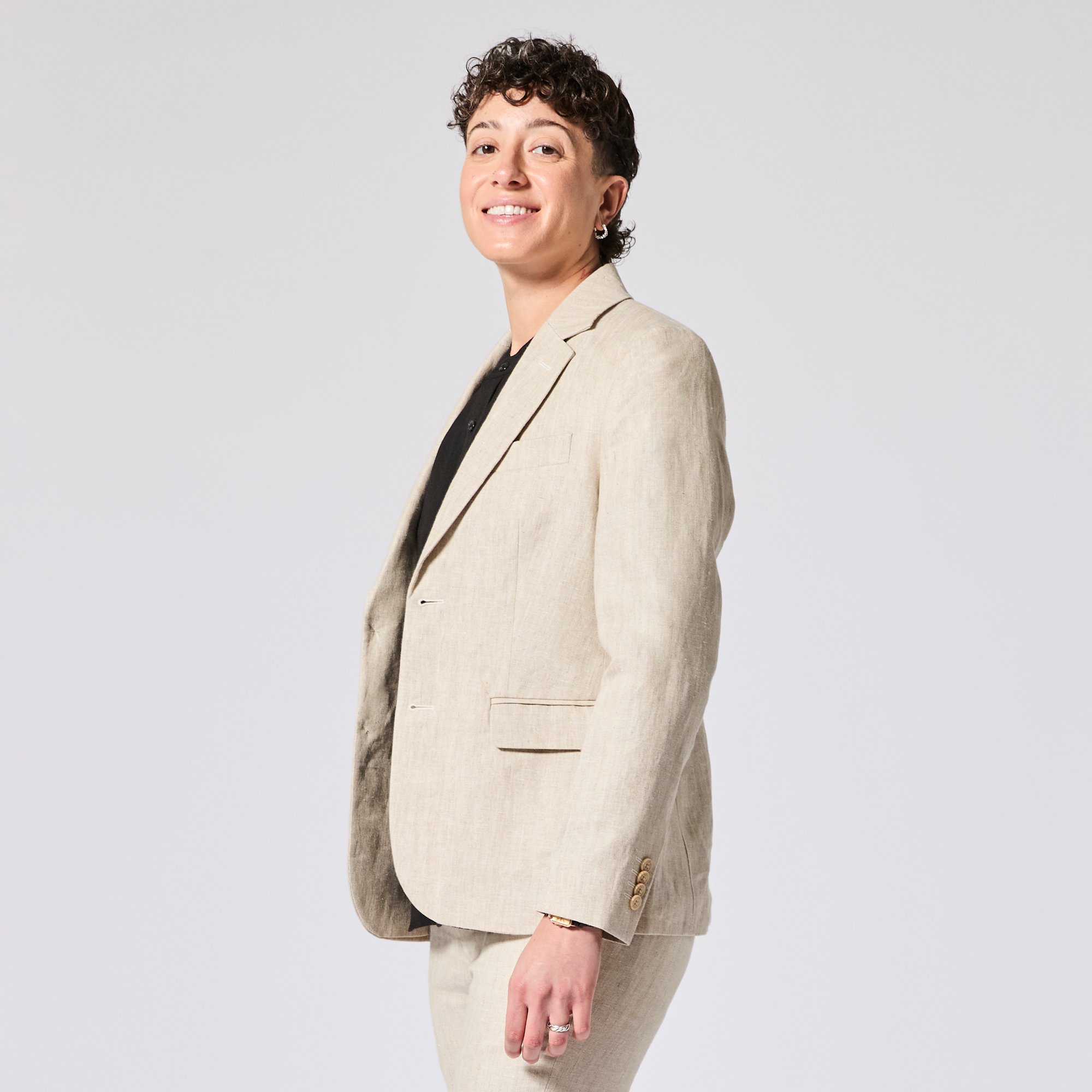 Person wearing a beige blazer on a plain background. Color: Khaki Herringbone
