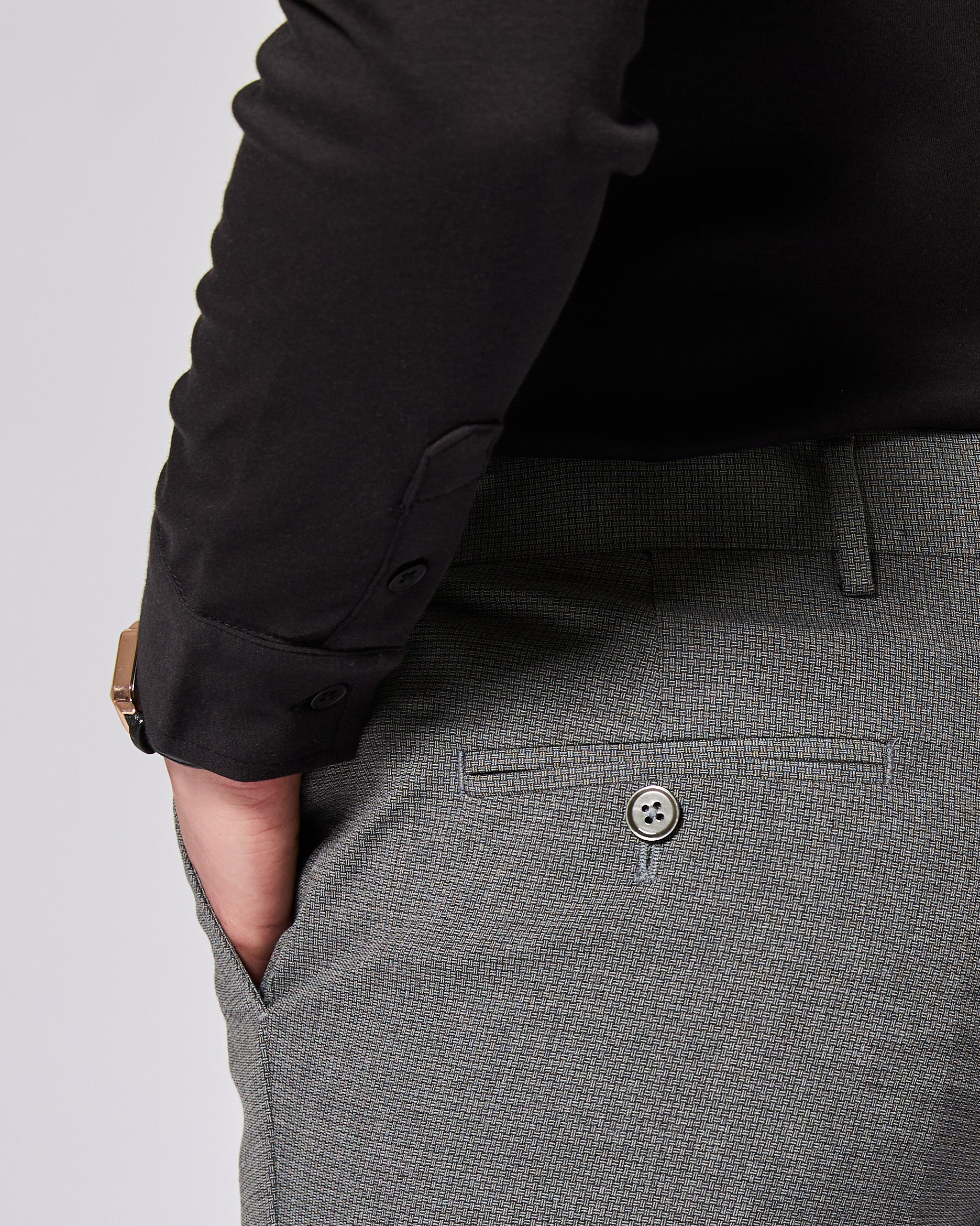 Gray pants with a button detail on a plain background. Color: Gray Lattice
