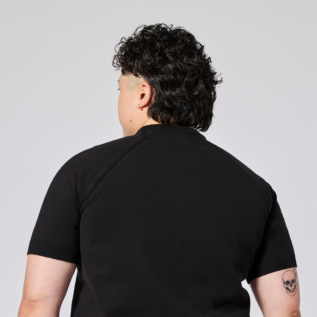 Androgynous black knit shirt made by Kirrin Finch. Color: Black
