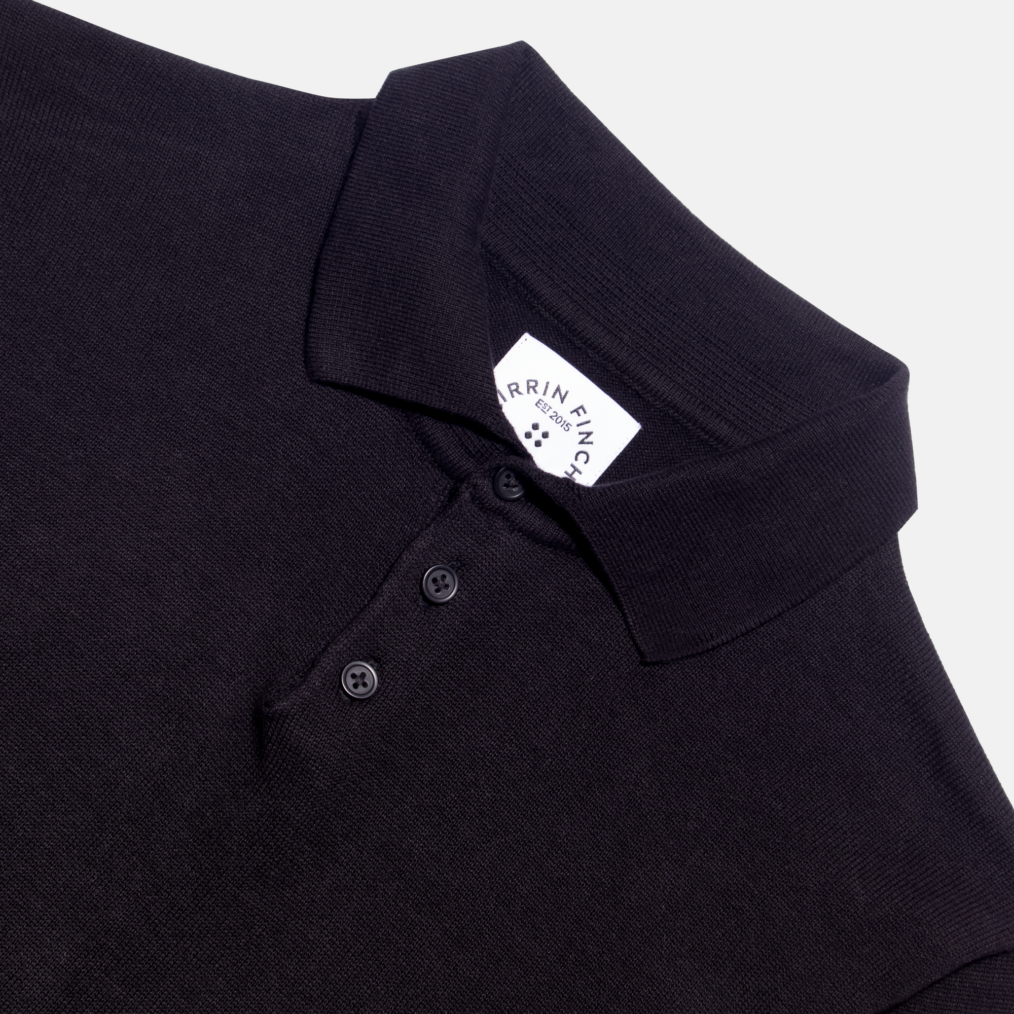 Flat lay shot of the long sleeve polo sweater made for women, trans, masc and non-binary folk.  Color: Black