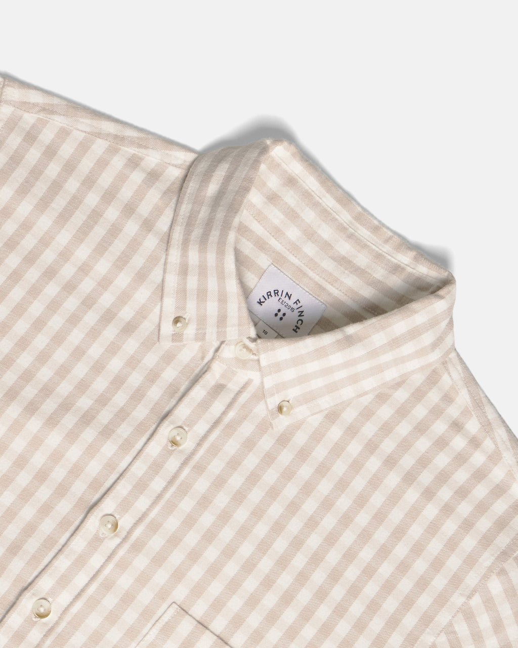 Close-up of a beige and white gingham button-down shirt collar. Color: Cream Check Flannel