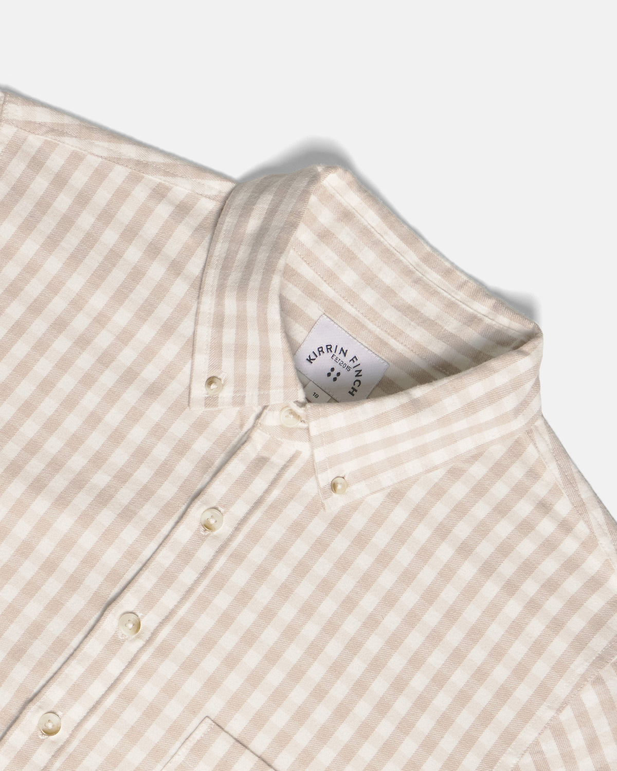 Close-up of a beige and white gingham button-down shirt collar. Color: Cream Check Flannel