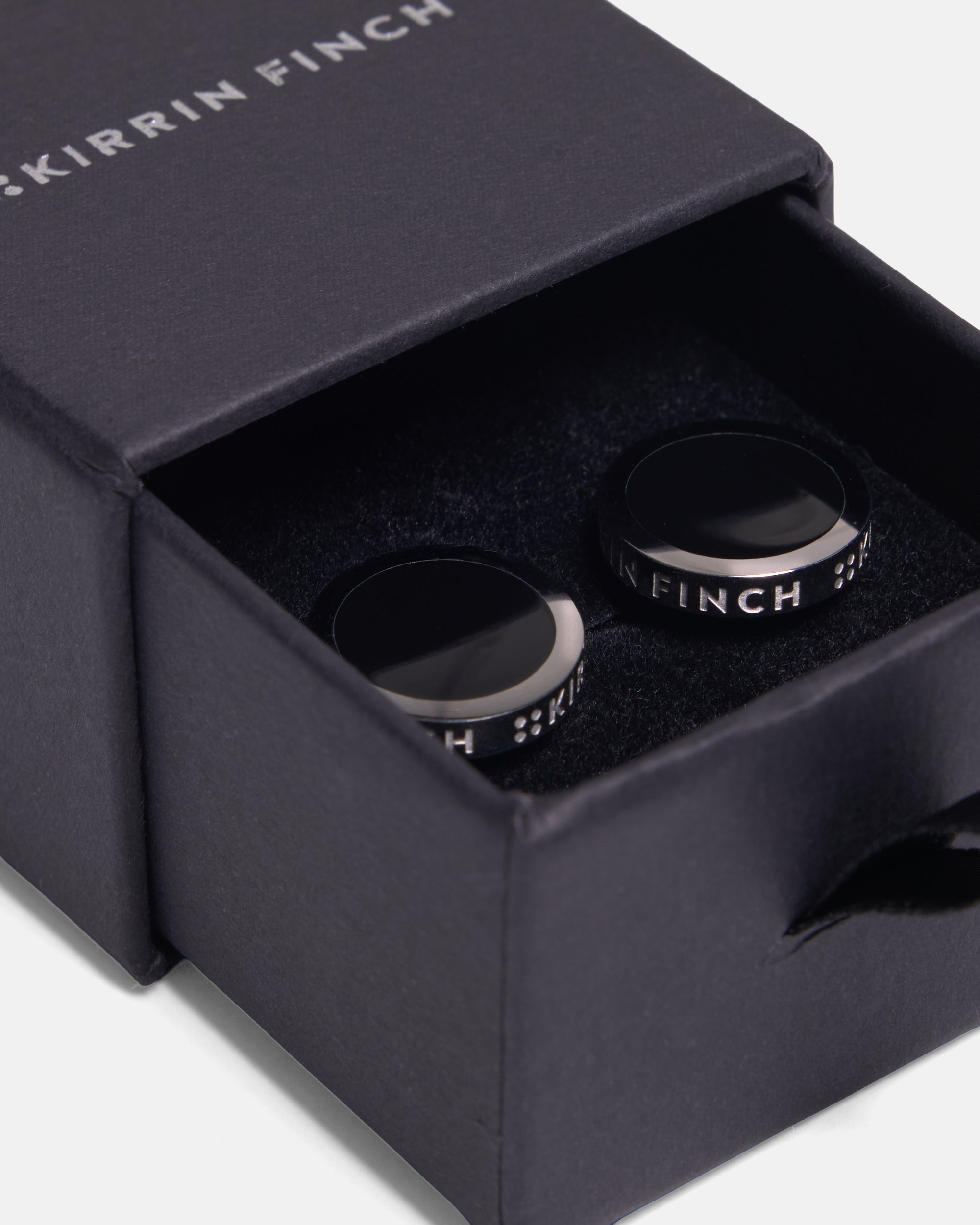 Kirrin FInch cufflinks sitting inside of a giftbox. 