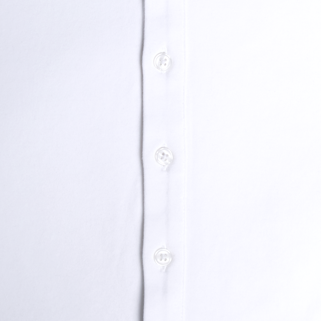 Close-up of a white shirt with button details on a light gray background. Color: White