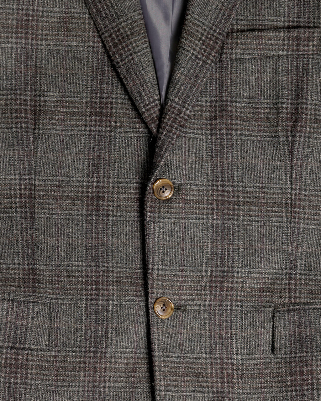 Close-up of a gray and brown plaid tweed blazer jacket, showing the fabric texture, two brown buttons, and a dark gray inner lining. Color: Earthen Glen Plaid