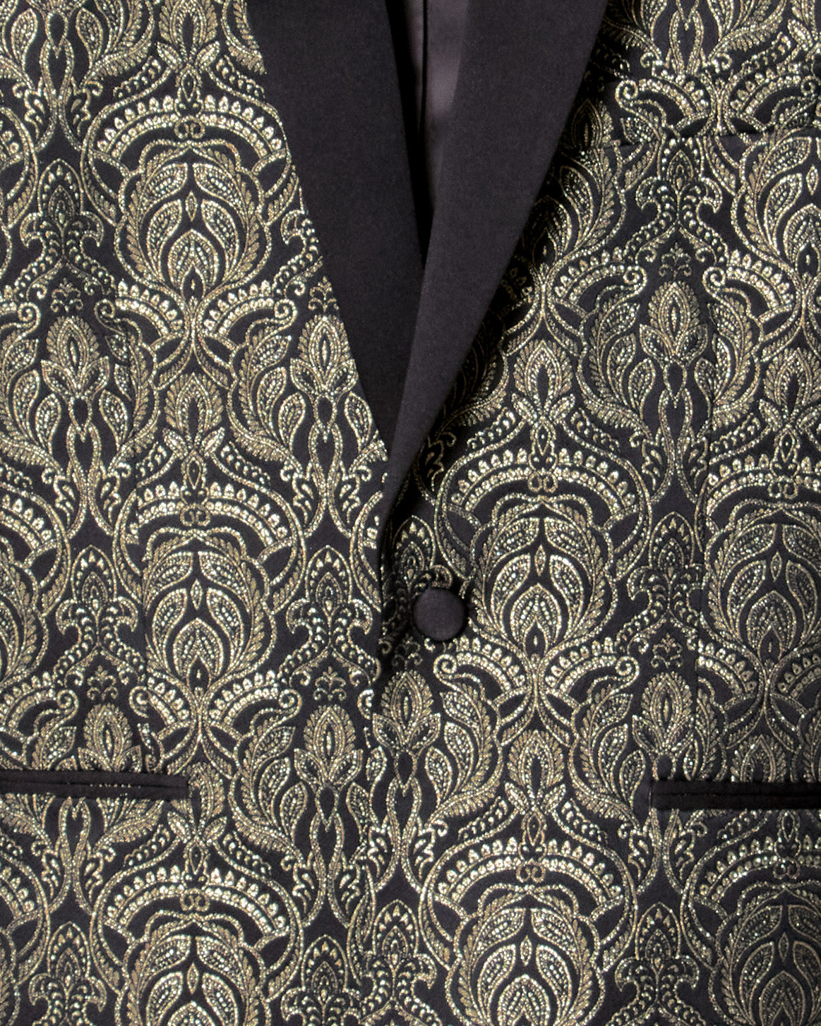 Close-up of a black and gold patterned suit jacket. Color: Gilded Brocade