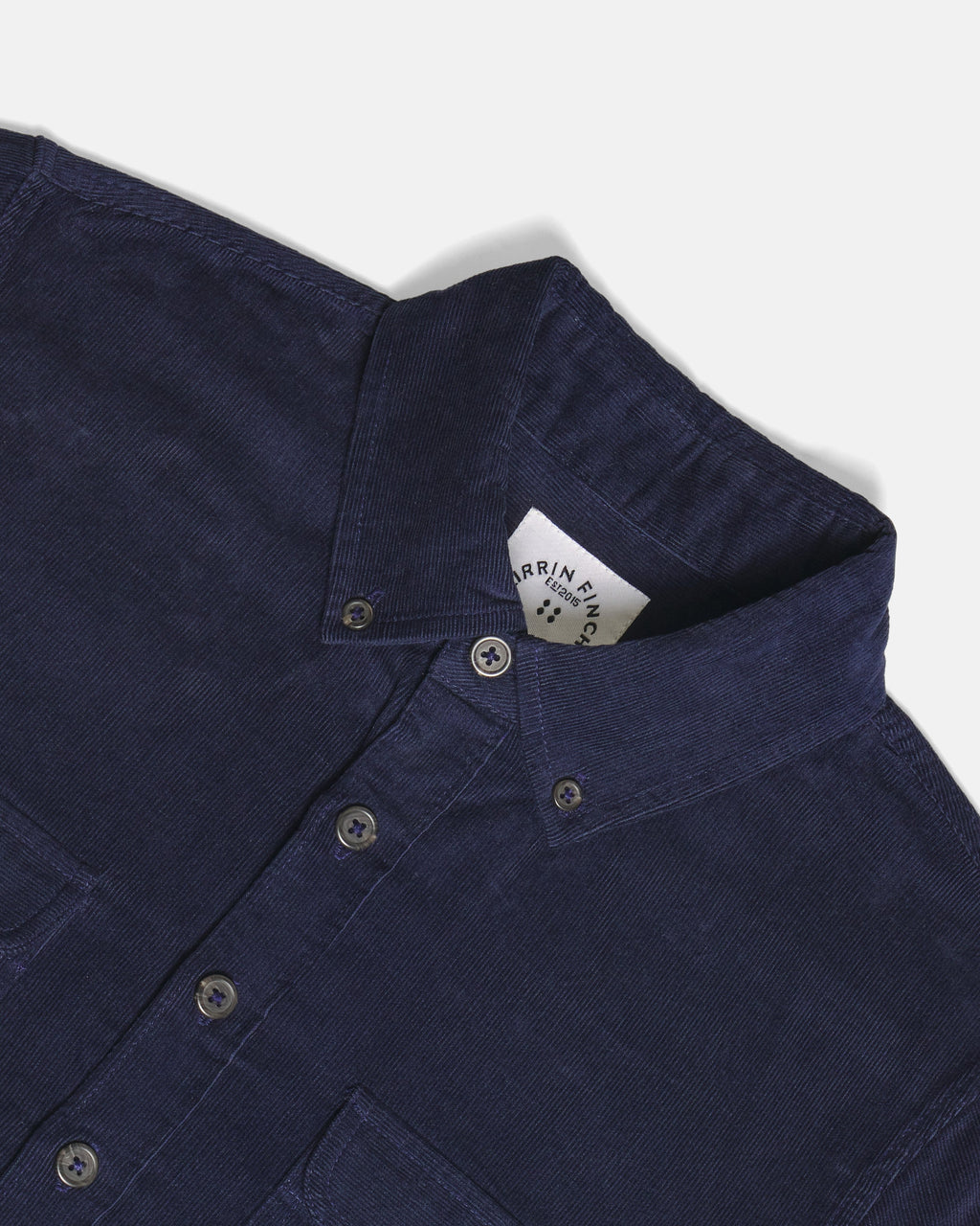 Close-up of a dark navy blue button-down shirt with a pointed collar. Color: Maritime Blue