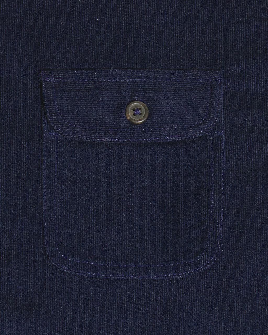 Close-up of a dark navy corduroy pocket with a buttoned flap on a matching navy corduroy garment. Color: Maritime Blue