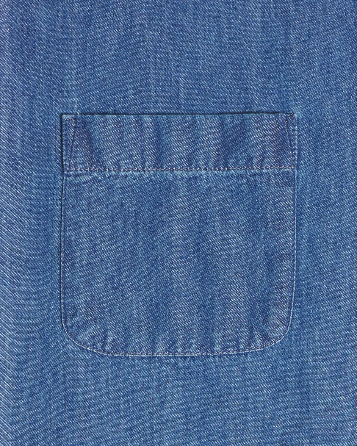 A close-up of a blue denim fabric with a single front patch pocket and visible stitching. Color: Medium Wash Denim