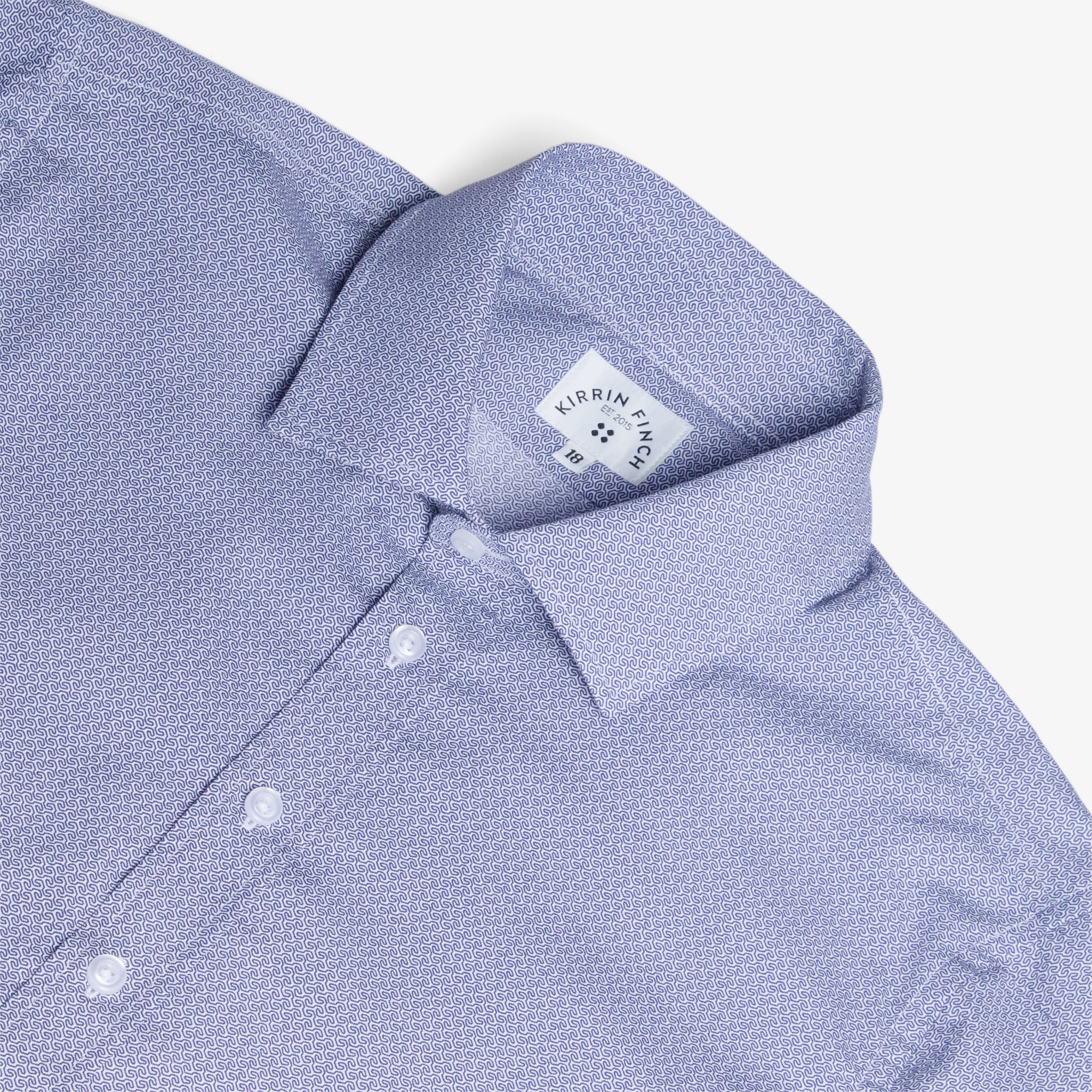 Close-up of a blue wave shirt with a Kirrin Finch logo on a white background. Color: Marine Mini Wave