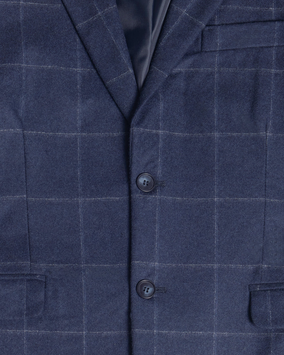 Close-up of a navy blue windowpane plaid blazer fabric, showing the texture, two dark buttons, and a dark satin collar lining. Color: Navy Regatta
