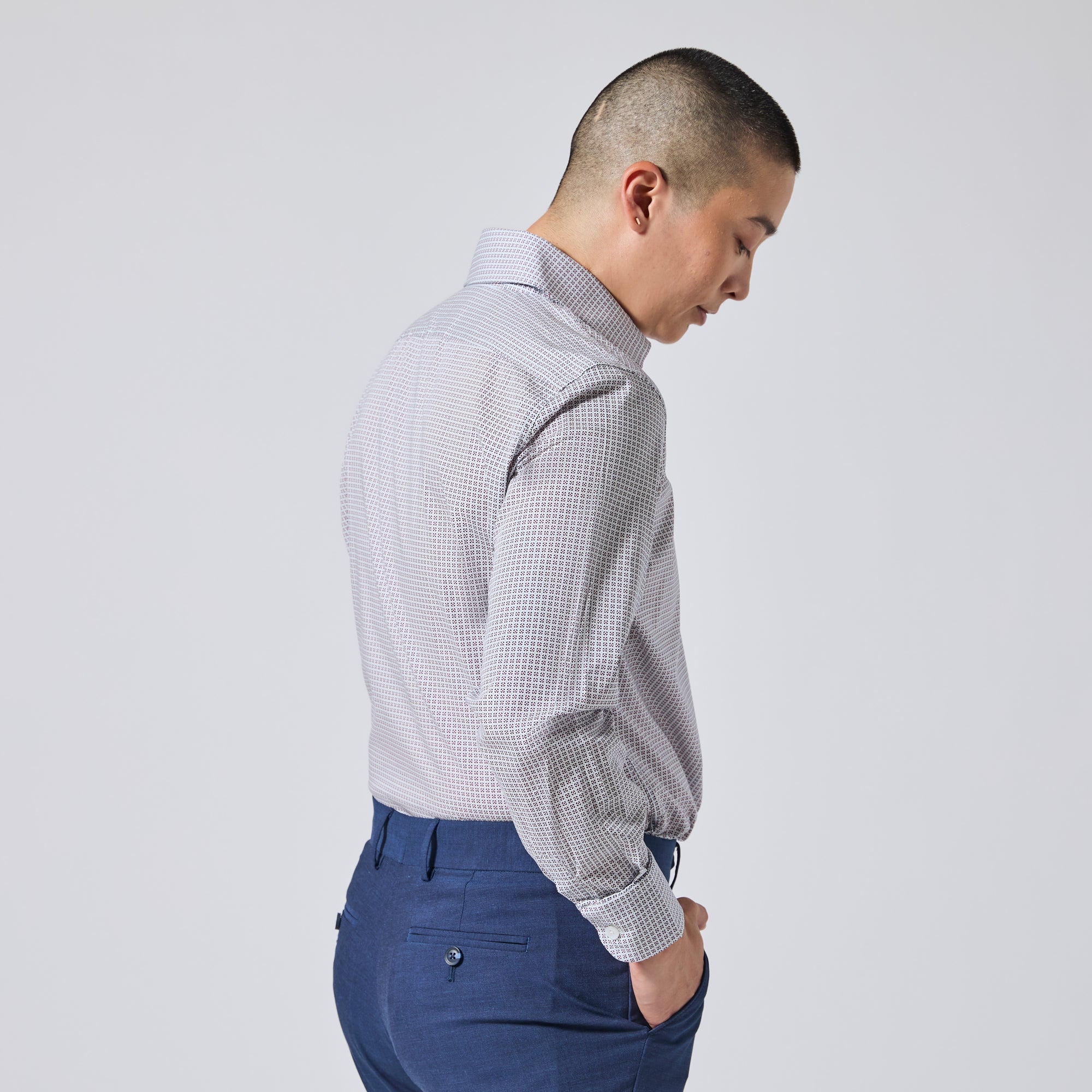 Model shown from the back and side wearing a light gray and white micro- patterned dress shirt. Color: Navy Rosette