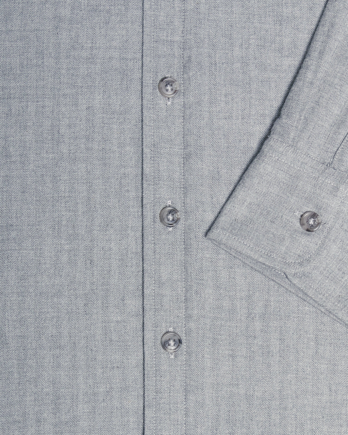 Close-up of a light gray textured button-down shirt showing the button placket and a folded cuff with a button. Color: Pewter Herringbone