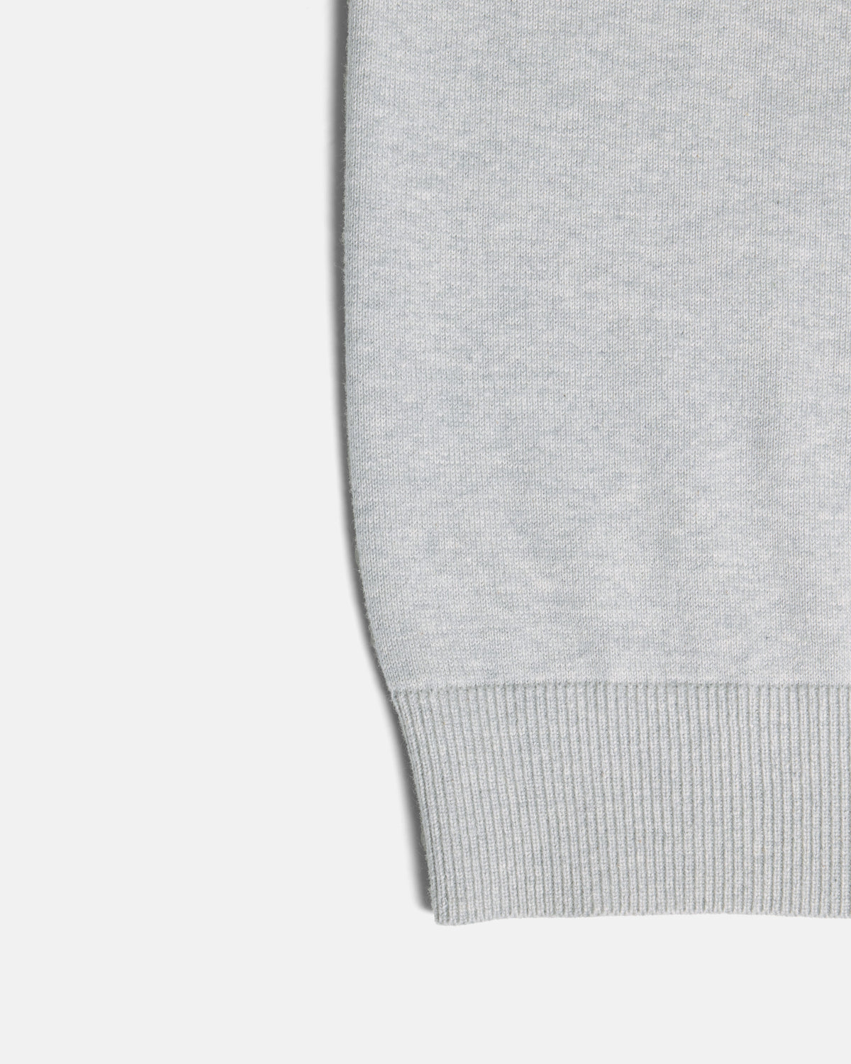 Close-up of a light gray ribbed knit cuff on a plain light background. Color: Heather Grey
