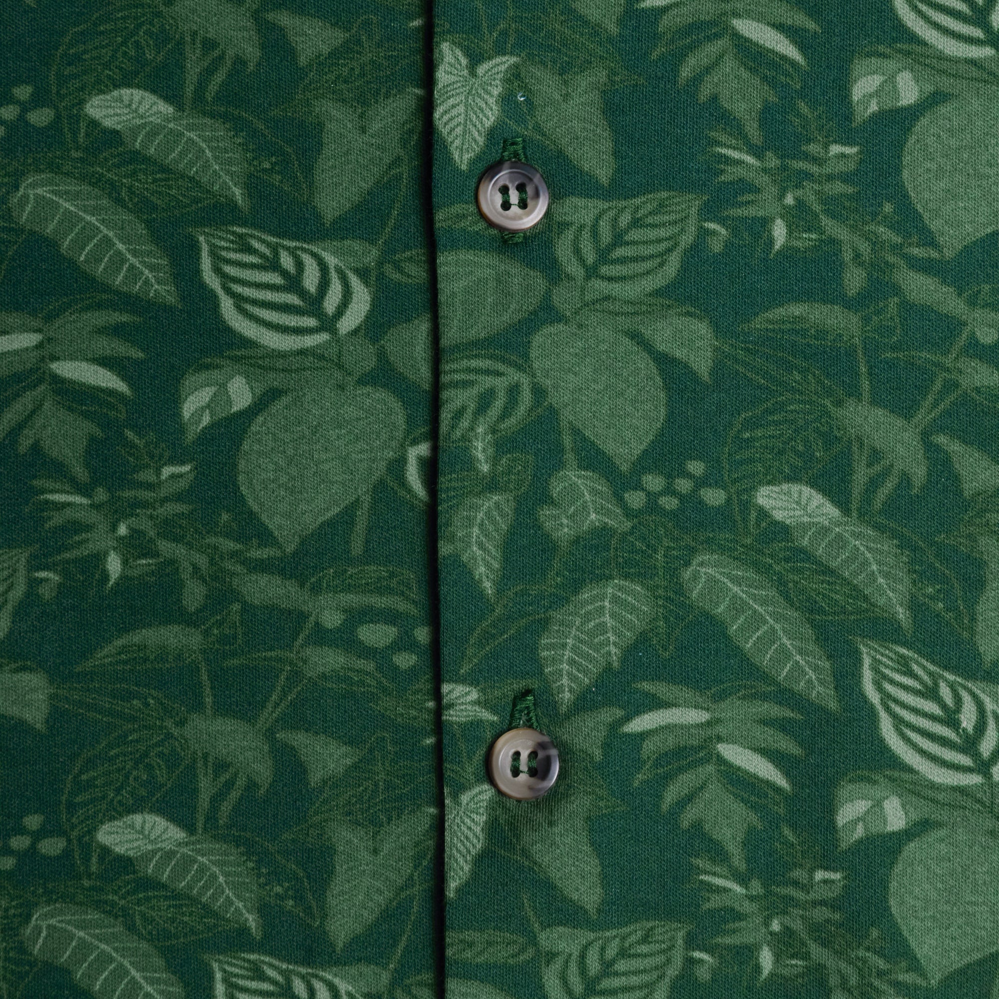 Close up of the jungle double jersey showing it's leaf patterns and button details. Color: Jungle