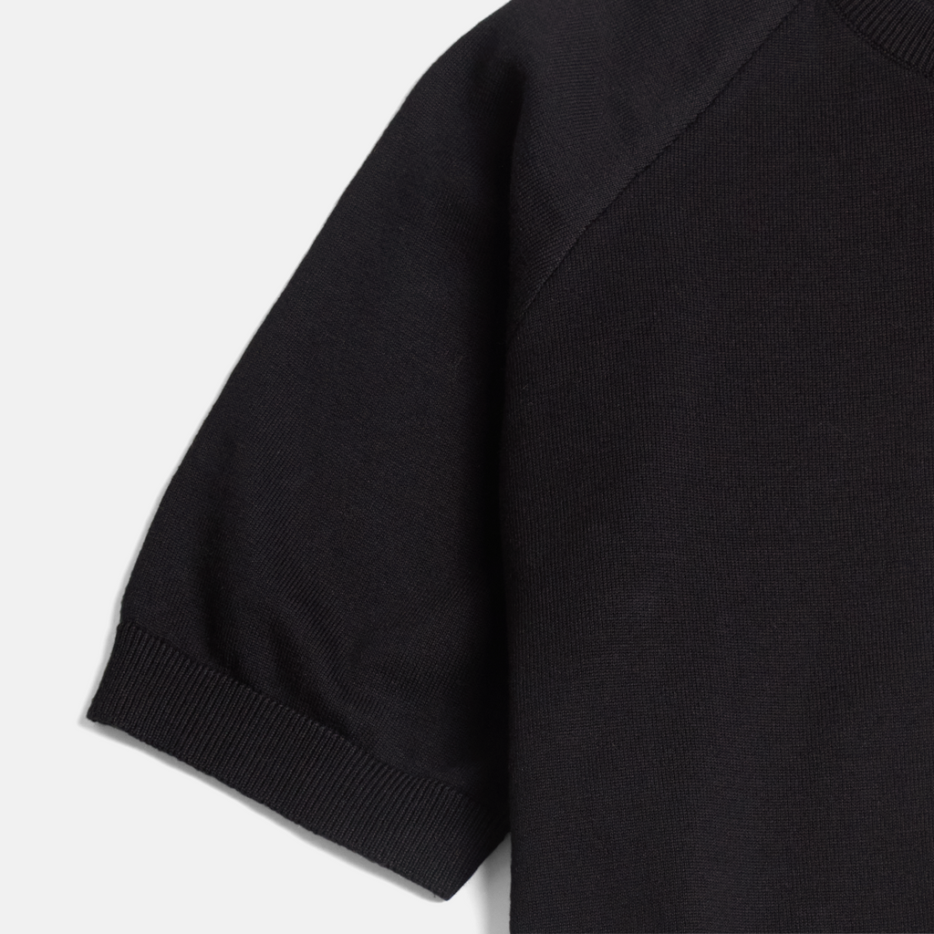Ribbed cuff of black crewneck shirt made by Kirrin Finch. Color: Black