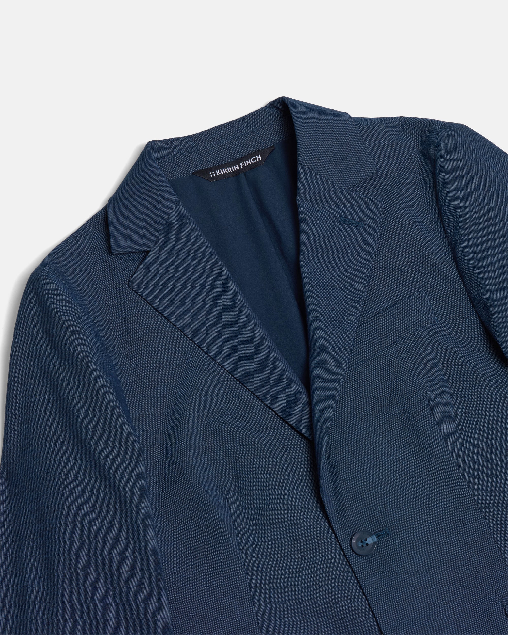 Blue blazer with a brand label on a light gray background. Color: Atlantic Blue