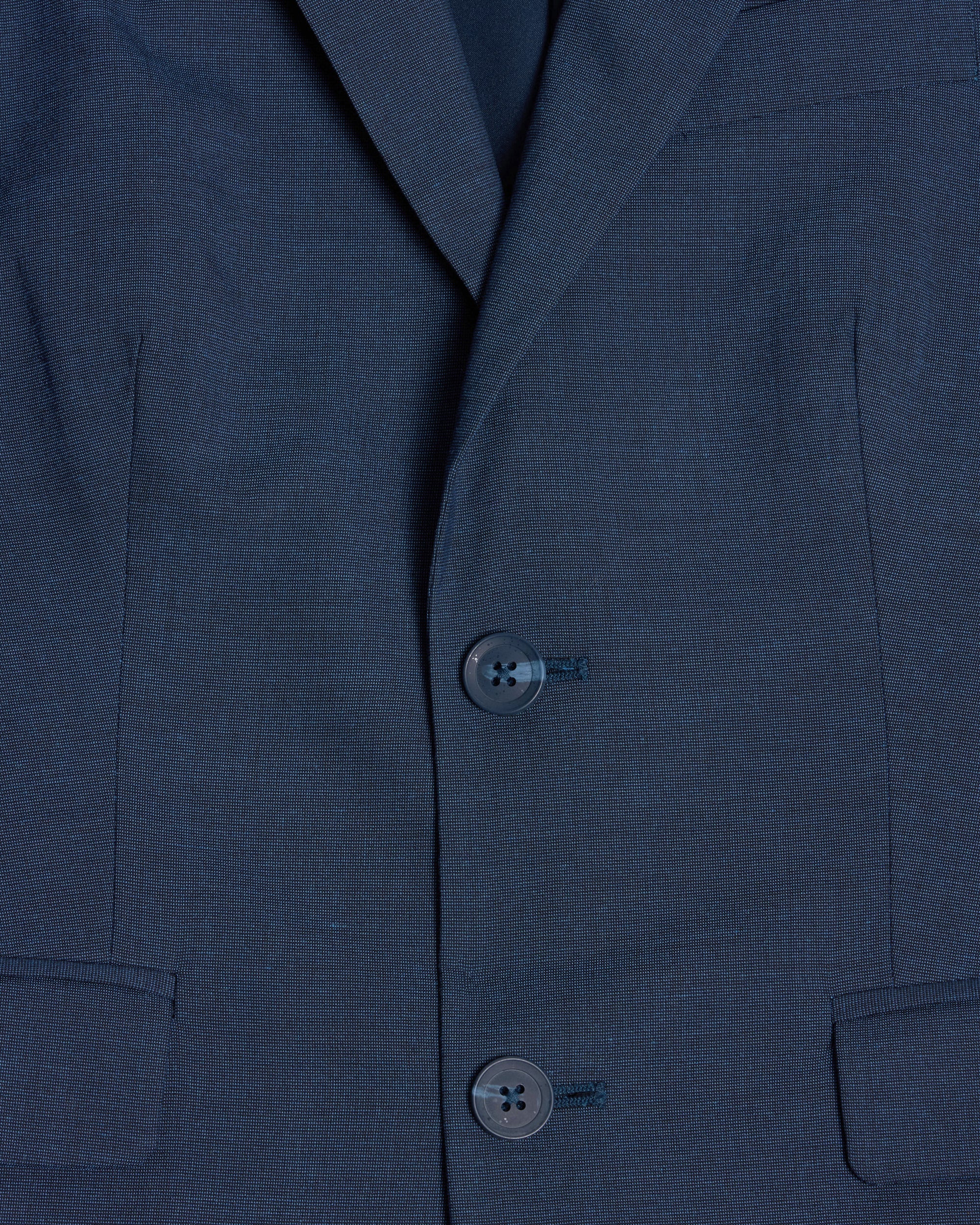Close-up of a blue suit jacket with buttons. Color: Atlantic Blue