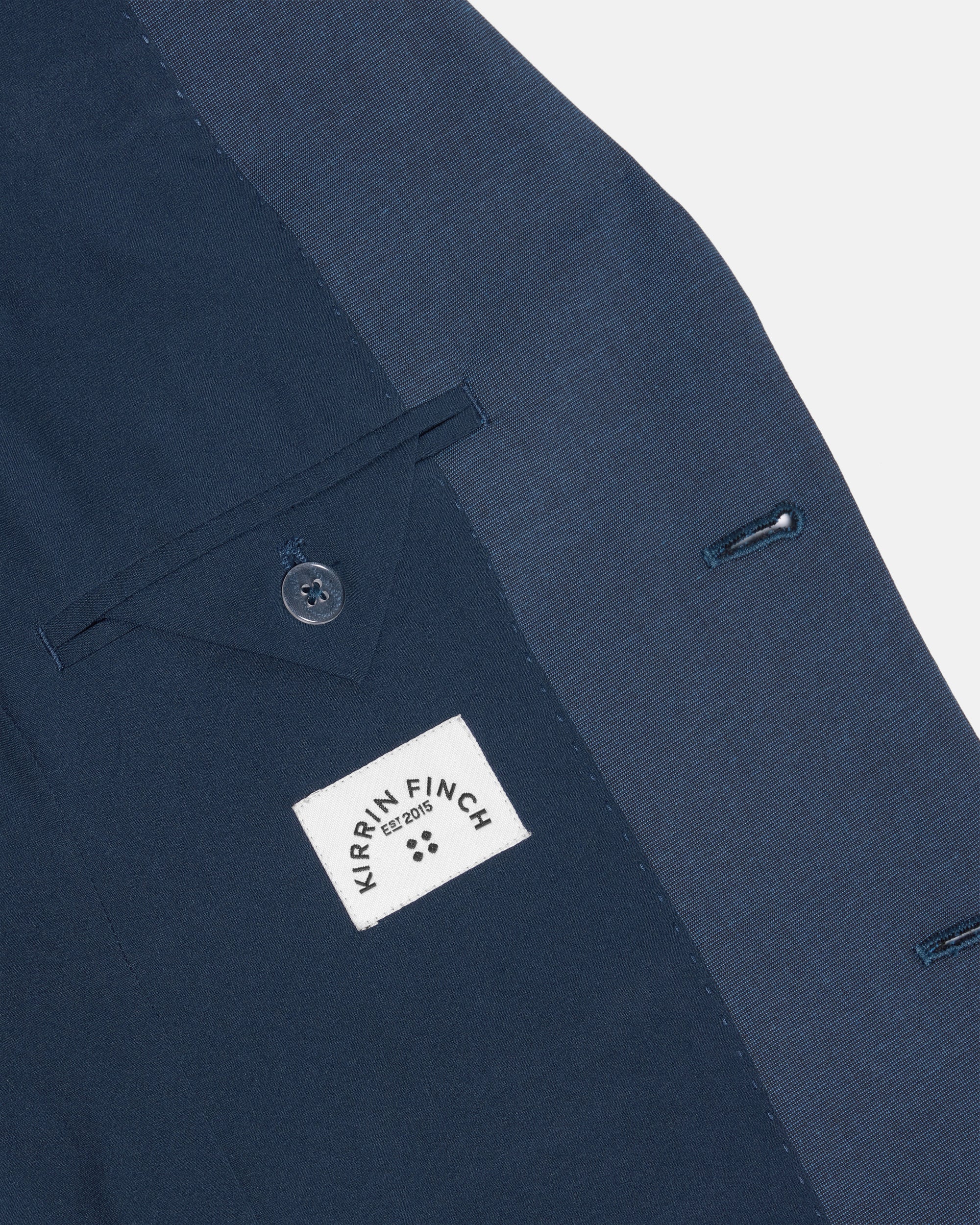 Navy blue suit jacket with a Kirrin Finch label on a white background. Color: Atlantic Blue
