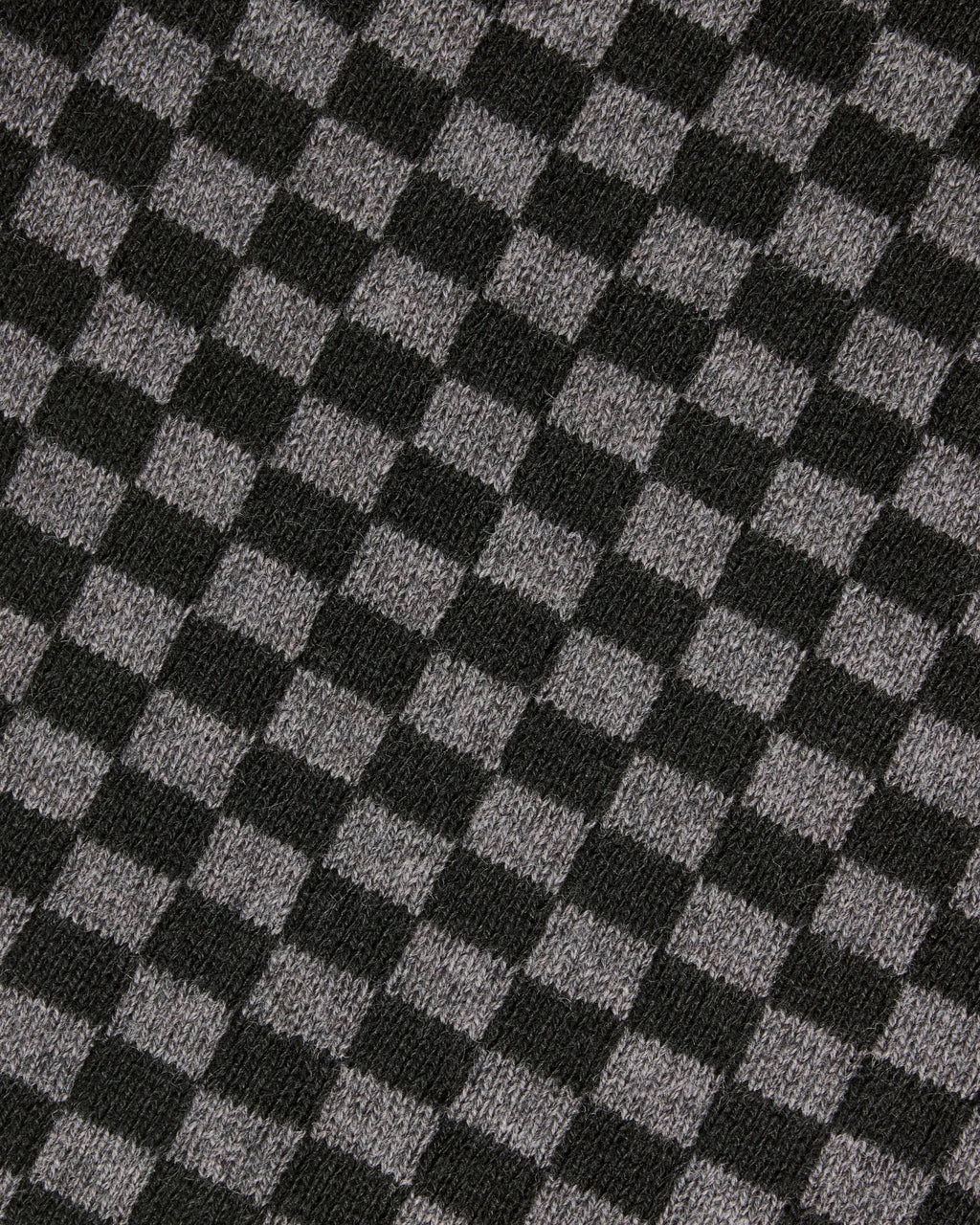 A close-up of a black and gray checkerboard knit fabric texture. Color: Shadow Checker