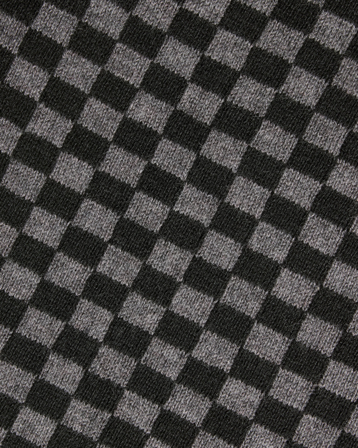 A close-up of a black and gray checkerboard knit fabric texture. Color: Shadow Checker