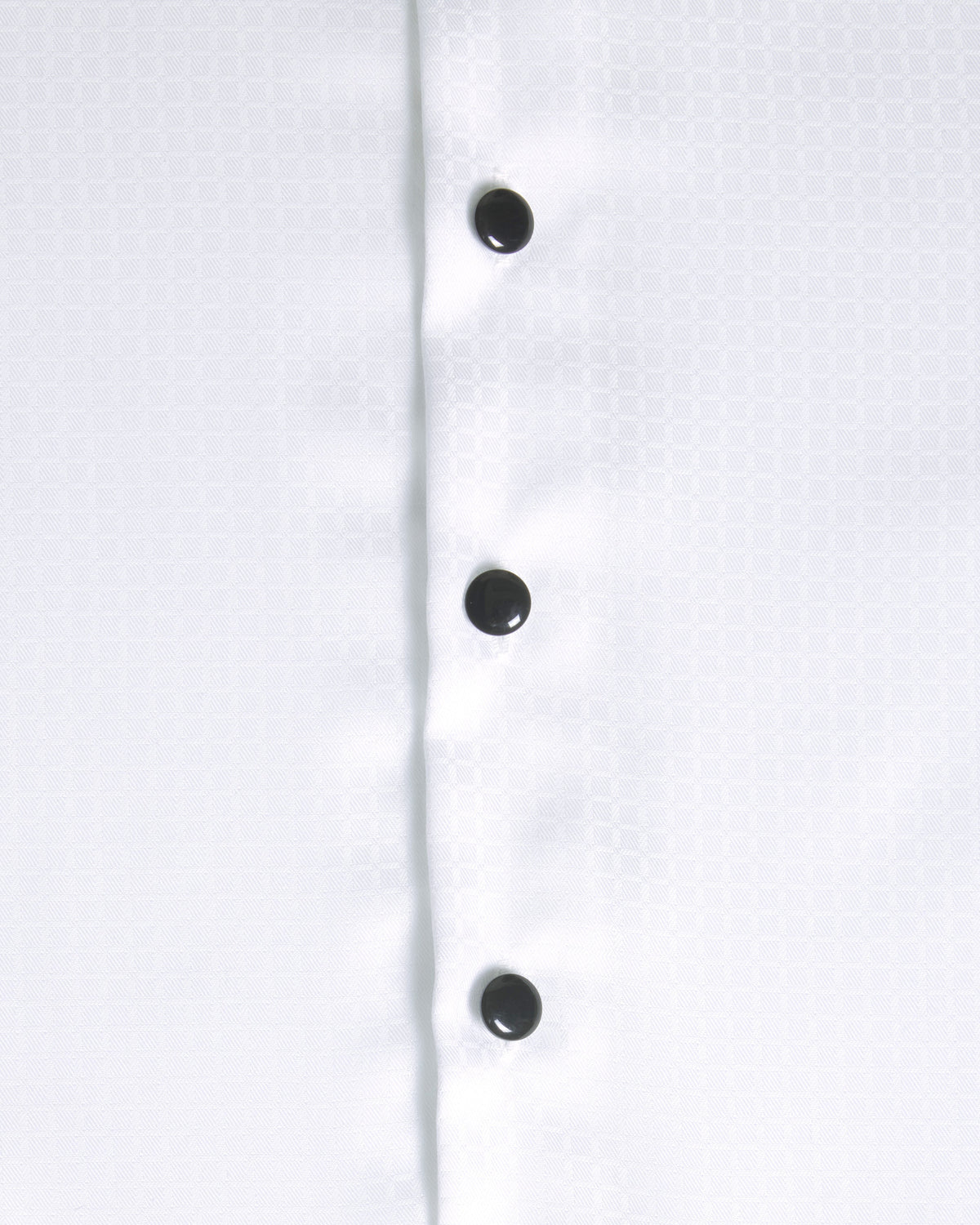 Close-up of a white button-down shirt showing the front placket with four black buttons and a subtle woven texture. Color: White Twill Grid