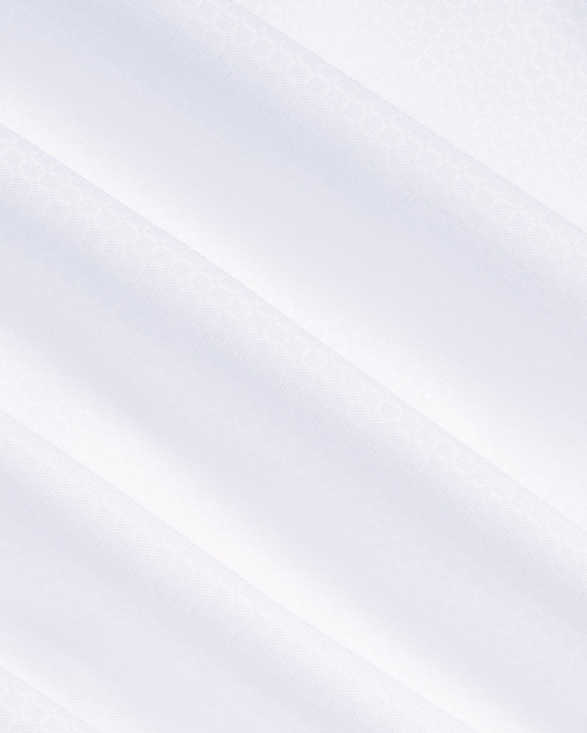 A close-up of a white fabric with a subtle, fine repeating damask pattern and soft diagonal folds. Color: White Twill Grid