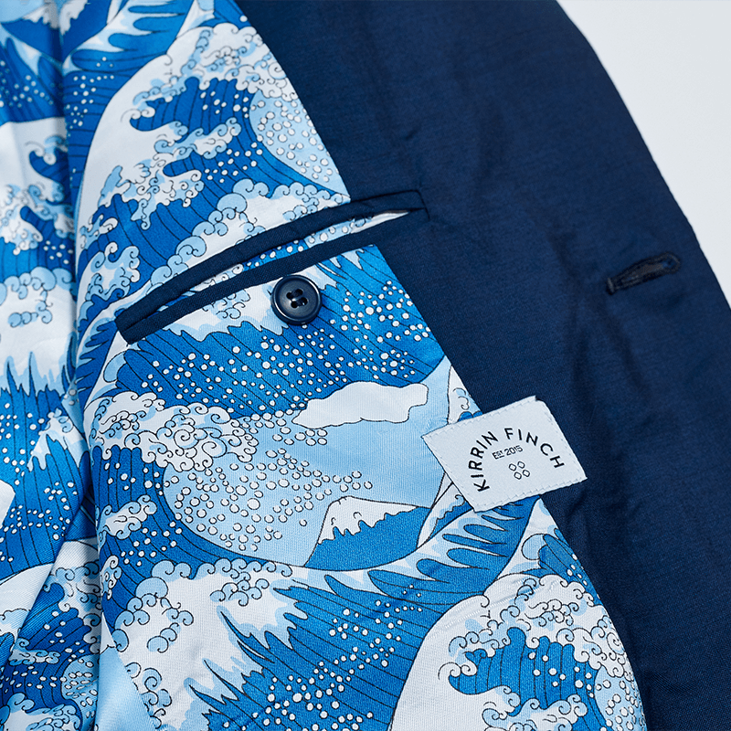The blue wave interior lining and inside pocket with button of the Georgie Navy Suit. Color: Navy