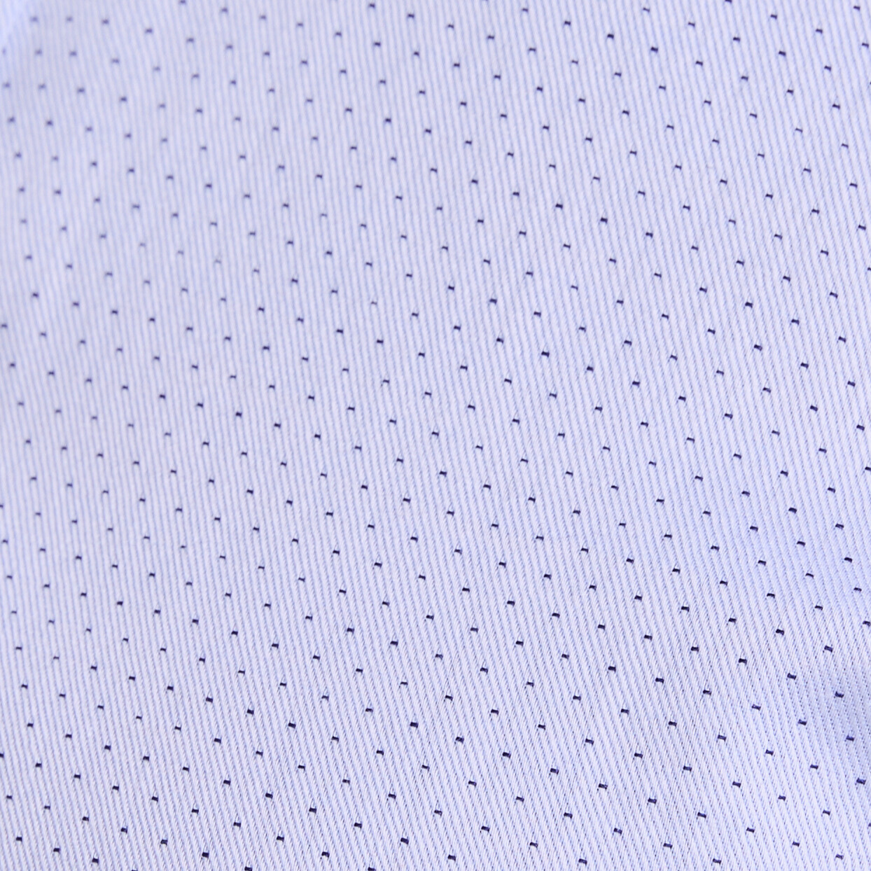 Close up shot of the Blue Swiss Dot Frankie dress shirt made for women.  Color: Blue Swiss Dot 