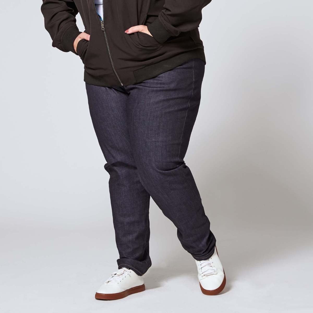 Plus size denim jeans paired with reversible bomber. Color: Indigo