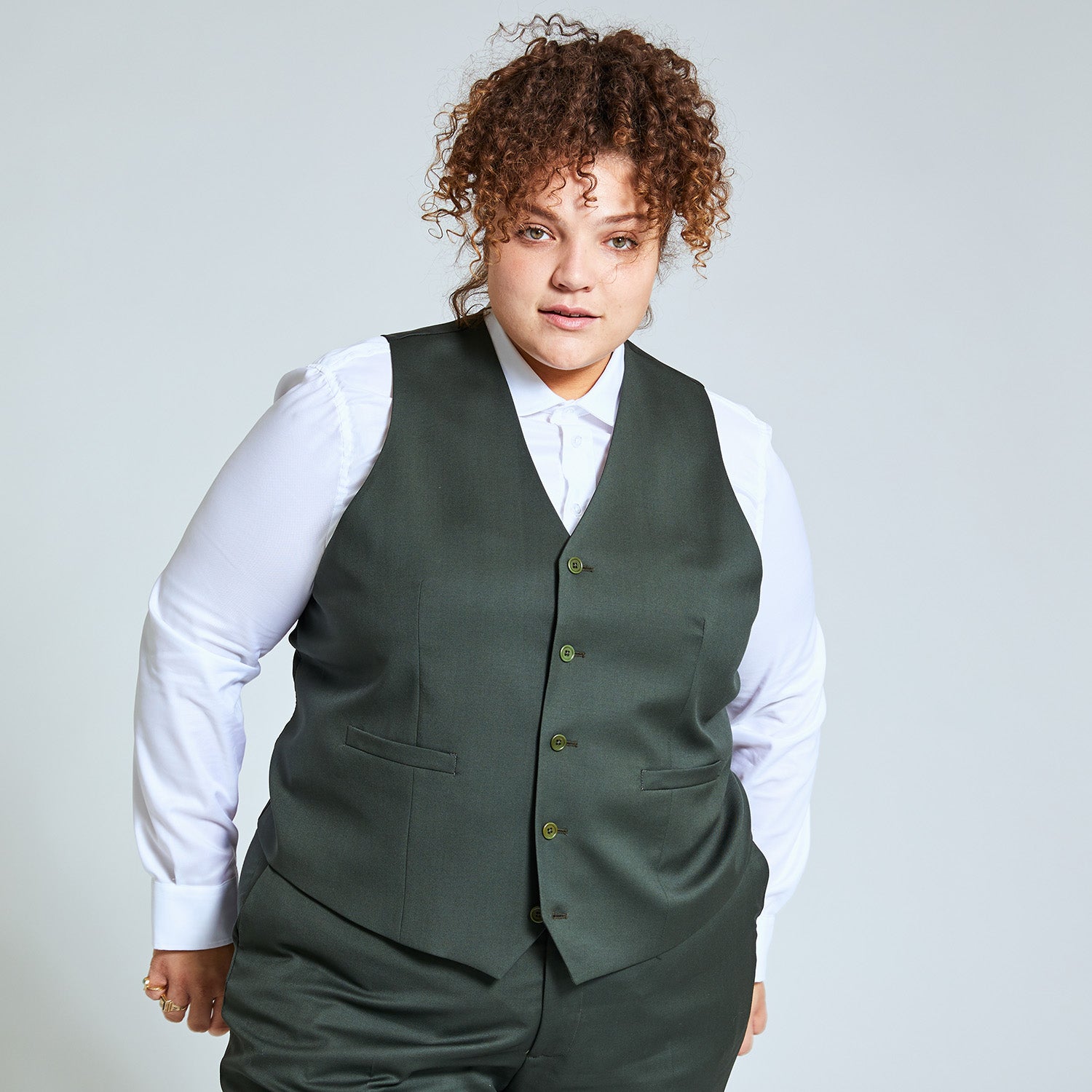 Androgynous person modeling the georgie olive vest and olive dress pants. Color: Olive